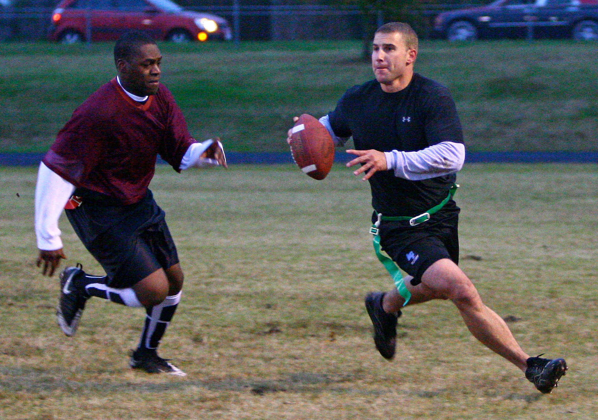 Panthers quarterback Casey Walterscheid scrambles from Roughnecks rusher Calvin Hall during the teams’ Oct. 21 flag football game. The Panthers struggled to get their offense clicking in the blustery conditions and fell to the fleet-footed Roughnecks squad 20-8. (Air Force photo by John Stuart)