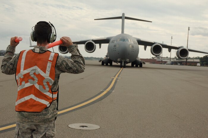 Airman First Class Mike Bowker marshals in Lt. Gen. Charles Stenner, Jr as he taxis in the newest C-17 addition to Charleston AFB Oct. 28. An all reserve crew delivered the C-17 bringing the total number of aircraft to 58. General Stenner is the commander of the Air Force Reserve Command and Airman Bowker is a crew chief assigned to the 437th Aircraft Maintenance Squadron. (U.S. Air Force photo/Staff Sgt. Marie Brown)