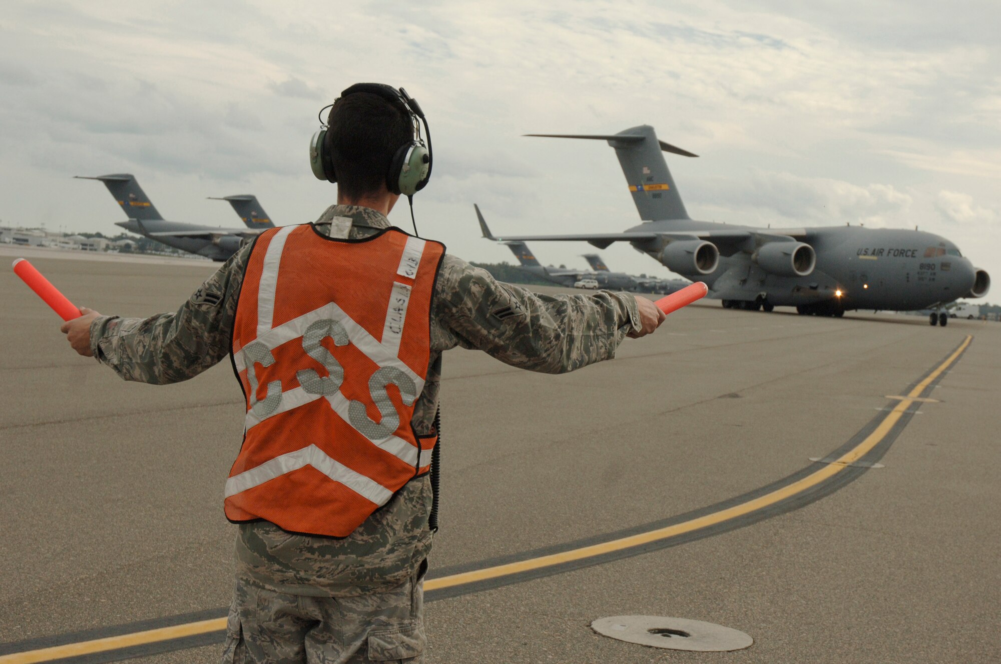 Airman First Class Mike Bowker marshals in Lt. Gen. Charles Stenner Jr., as he taxis in the newest C-17 addition to Charleston AFB Oct. 28. An all Reserve crew delivered the C-17 bringing the total number of aircraft to 58. General Stenner is the commander of the Air Force Reserve Command and Airman Bowker is a crew chief assigned to the 437th Aircraft Maintenance Squadron. (U.S. Air Force photo/Staff Sgt. Marie Brown)