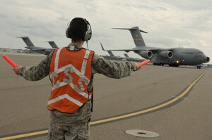 Airman First Class Mike Bowker marshals in Lt. Gen. Charles Stenner Jr., as he taxis in the newest C-17 addition to Charleston AFB Oct. 28. An all Reserve crew delivered the C-17 bringing the total number of aircraft to 58. General Stenner is the commander of the Air Force Reserve Command and Airman Bowker is a crew chief assigned to the 437th Aircraft Maintenance Squadron. (U.S. Air Force photo/Staff Sgt. Marie Brown)