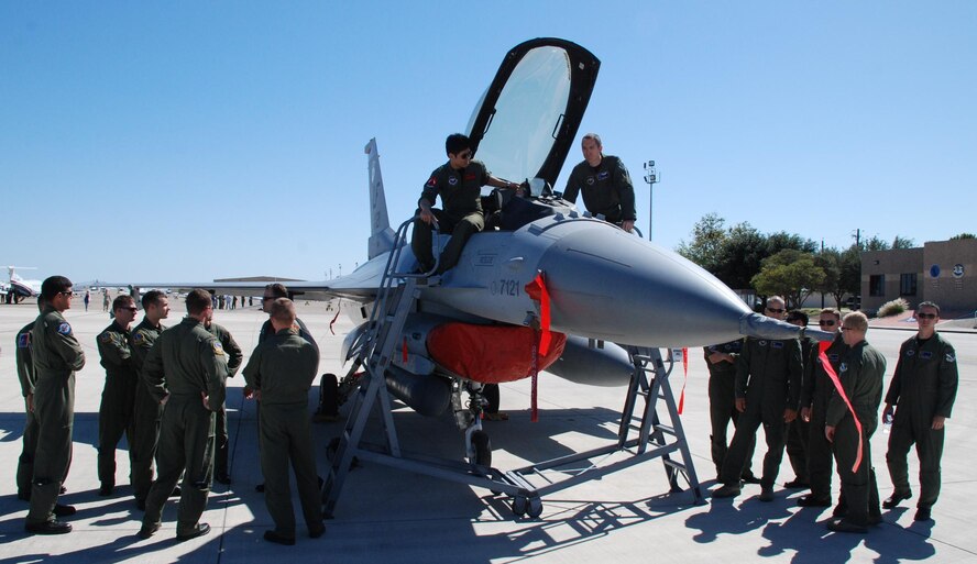 LAUGHLIN AIR FORCE BASE, Texas – Capt. Calvin Lim answers questions posed by Laughlin’s Specialized Undergraduate Pilot Training students about the finer points of being an F-16 fighter pilot during Major Weapons Systems day on the flight line here Oct. 24. MWS day was held so student pilots could get a hands-on look at operational aircraft and their capabilities. (U.S. Air Force photo by Airman 1st Class Blake Mize)