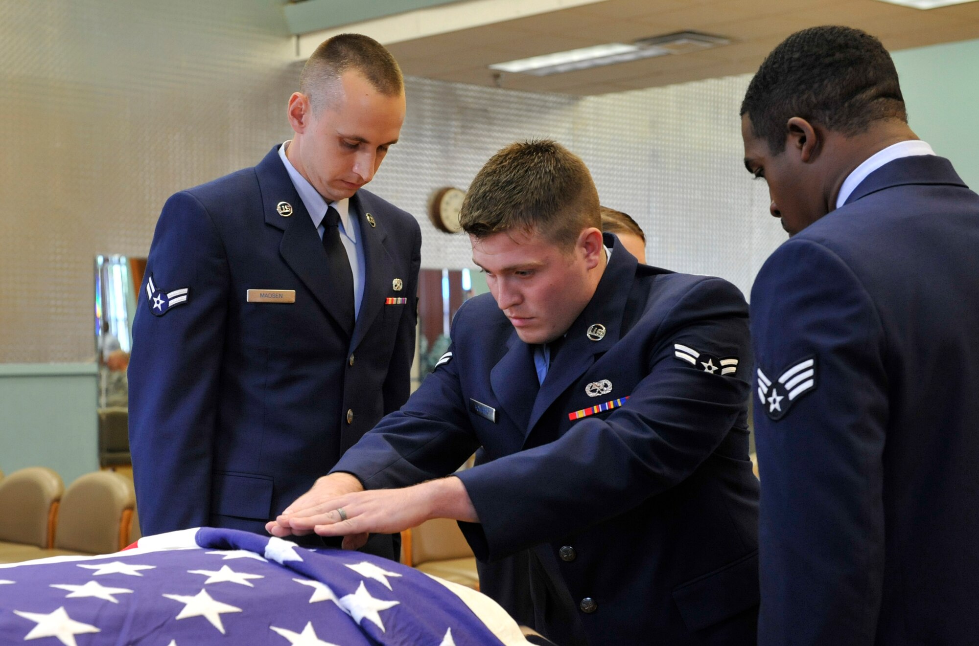 (From left) Honor guard graduates Airmen 1st Class Christian Madsen, Brian Howard and Senior Airman Terrance Walton, perform a visual inspection before removing a casket from a hearse during a mock funeral ceremony on base Oct. 19. The Little Rock Air Force Base Honor Guard mission is to provide military honors for deserving veterans, retirees, active duty, Guard and Reserve members on base, in Arkansas and the surrounding area on behalf of the president of the United States, the department of the Air Force and a grateful nation. The honor guard performs more than 55 ceremonies on average per month. (U.S. Air Force photo by Airman 1st Class Lausanne Pacheco)