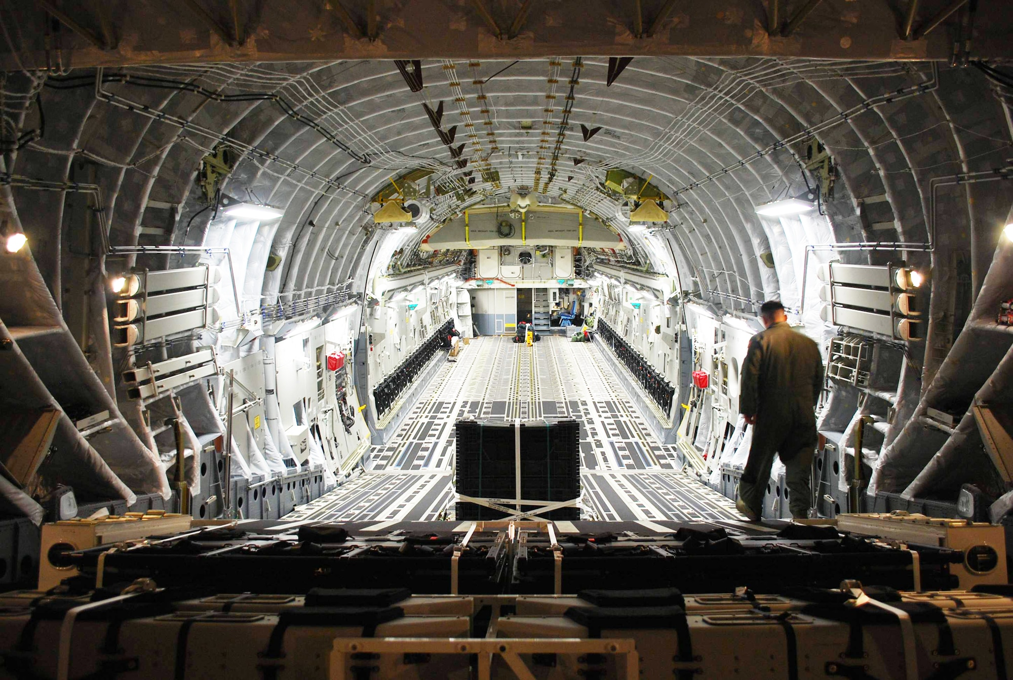 Master Sgt. Michael Lang inspects the inside of the newest C-17 Globemaster III to be delivered Oct. 28, 2009, at Charleston Air Force Base, S.C. Lt. Gen. Charles E. Stenner Jr., the commander of Air Force Reserve Command, accompanied by an all-Reserve crew from the 317th Airlift Squadron presented a ceremonial key to Col. Steven Chapman, the 315th Airlift Wing commander, on the flightline here, commemorating the Air Force receiving the 190th C-17 and the 58th aircraft at Charleston AFB. Sergeant Lang is a 317th Airlift Squadron loadmaster. (U.S. Air Force photo/Debra Baldwin) 