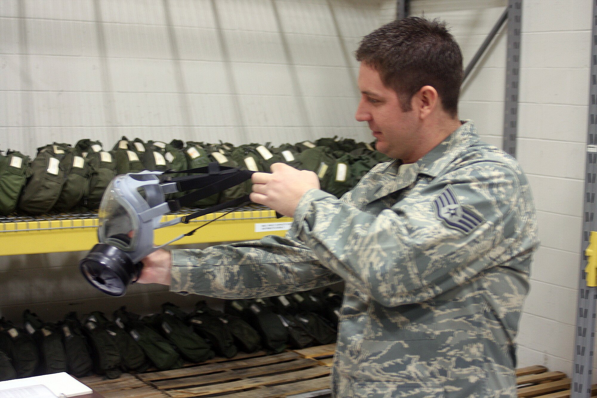 WRIGHT-PATTERSON AIR FORCE BASE, Ohio – Staff Sgt. Ryan Maloney, 445th Airlift Wing Logistics Readiness Squadron, inspects a chemical/biological mask to make sure it is serviceable for a reservist to use.  Sergeant Maloney constantly inventories the masks to make sure they are serviceable and that there are plenty in stock for future use.  (U. S. Air Force photo/Senior Airman Mikhail Berlin)
