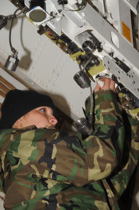ELLSWORTH AFB, S.D. -- Airmen 1st Class Danielle Tompkins, 34th Aircraft Maintenance Unit weapons apprentice, conducts maintenance on the B-1B Lancer's weapon bay, Oct. 28.  Airmen ensure they wear all the proper cold weather gear while working outside. (U.S. Air Force photo/Airman 1st Class Anthony Sanchelli)