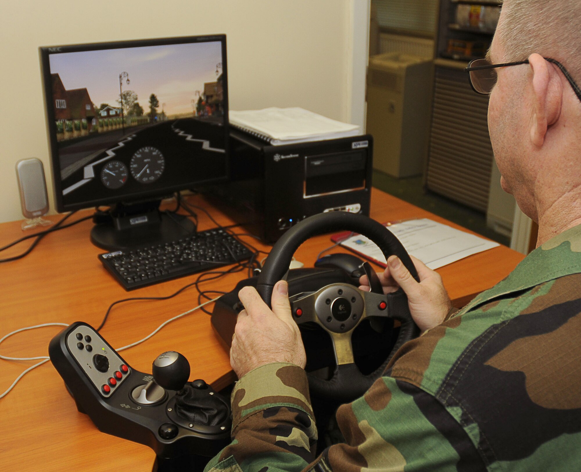 Senior Master Sgt. Jeff Gillogly, 48th Fighter Wing Safety Office flight safety NCO in charge, maneuvers on virtual streets on the XP 100 Virtual Traffic Safety System, an interactive system with realistic driving scenarios encountered every day in the UK. The system has multiple courses that deal with common road issues, such as following, hazard perception and pedestrians in a safe environment. (U.S. Air Force photo by Staff Sgt. Megan Lyon)