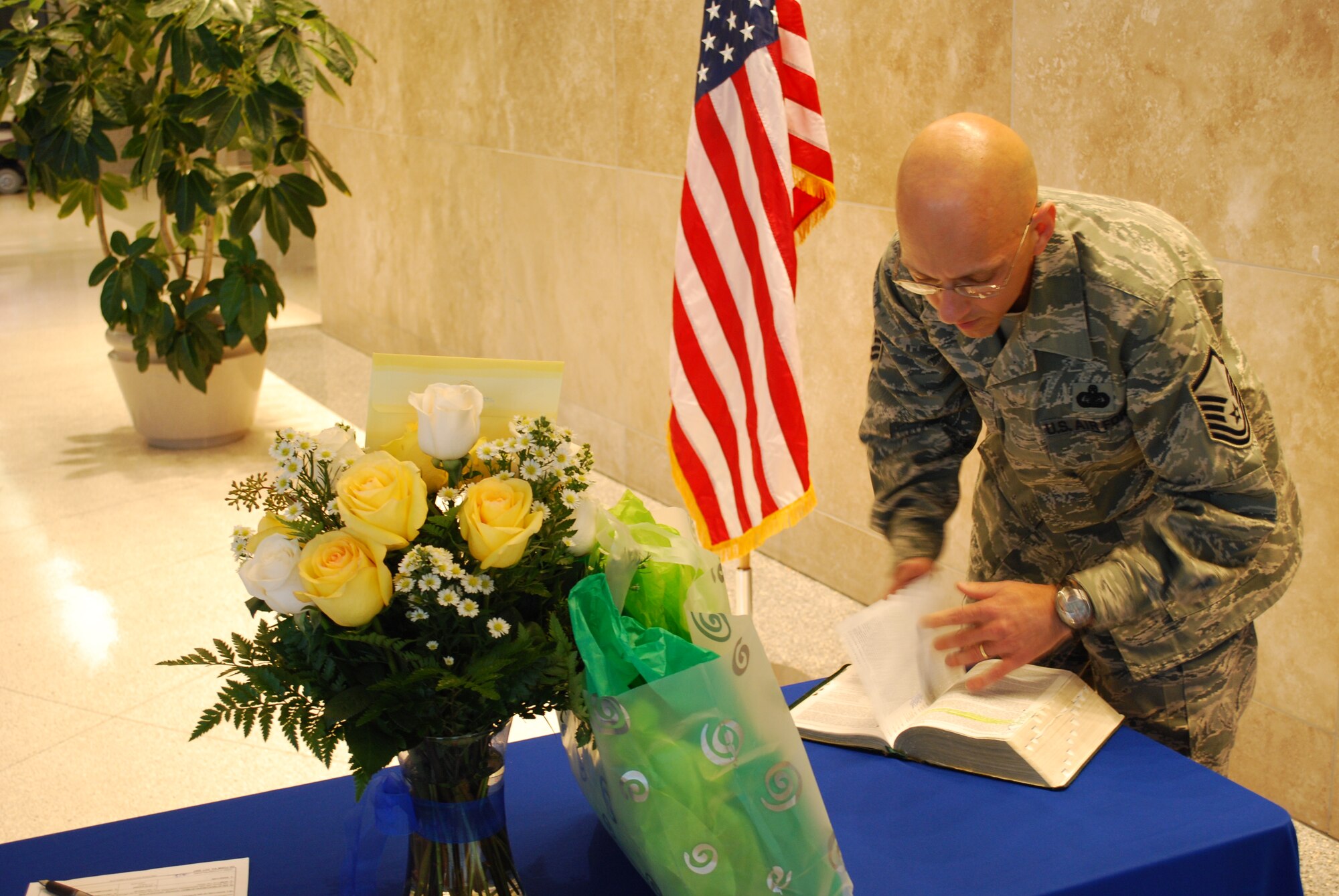 Master Sgt. Mike Sanders, a Knowledge Operations Manager for the 618th Tanker Airlift Control Center's Current Operations Directorate, prepares remarks during his re-enlistment ceremony, Oct. 28.  Sergeant Sanders celebrated his first re-enlistment following a year-long bout with cancer, and held his re-enlistment ceremony among friends and medical staff that helped him through the cancer treatment and recovery process.  Sergeant Sanders was re-enlisted by Second Lieutenant Sarah Foster, a former cadet and student of Sergeant Sanders when he served as an instructor at the University of Portland’s Air Force Reserve Officer Training Corps Program. (U.S. Air Force photo/Capt. Justin Brockhoff)