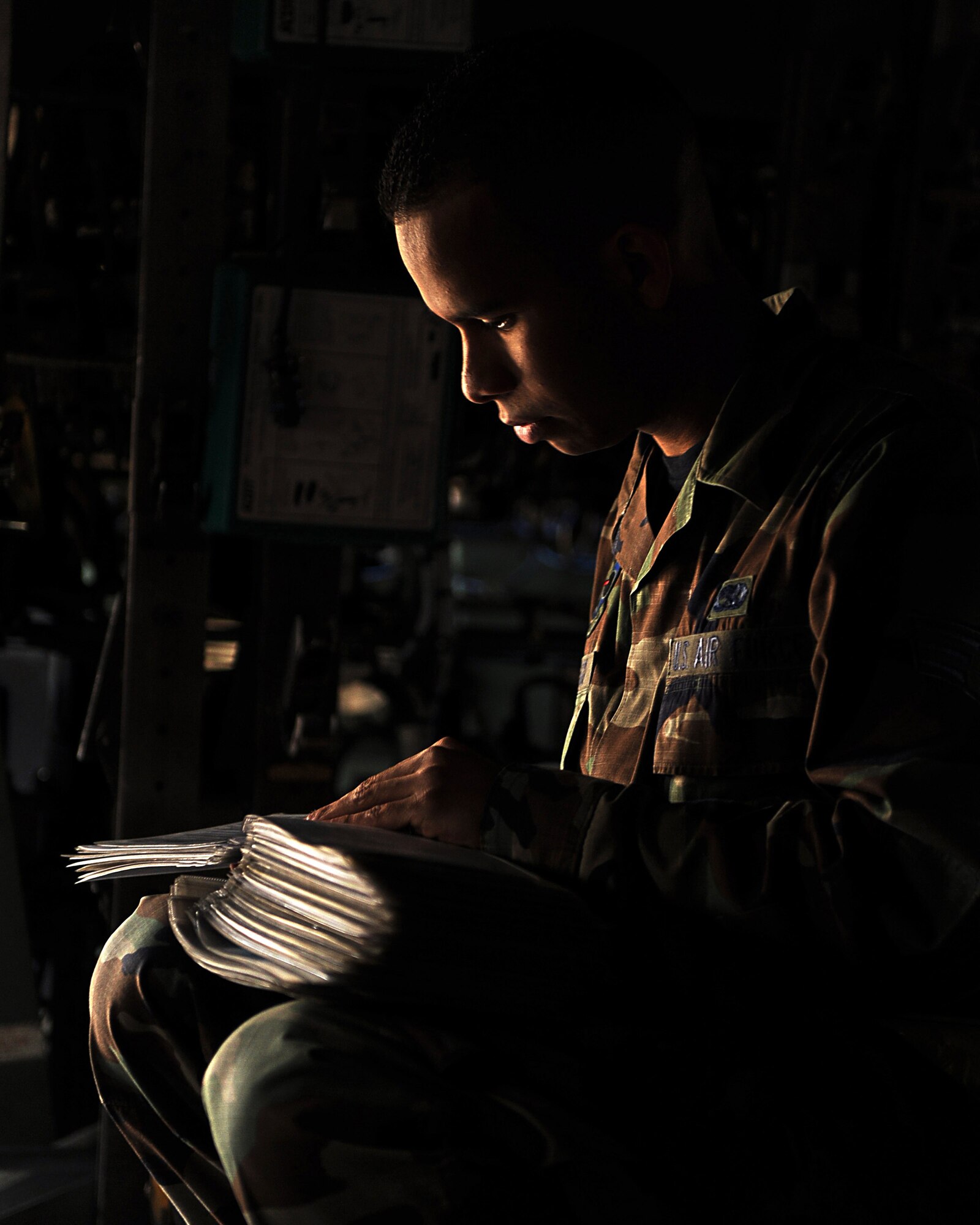 Senior Airman Frank Santiago, a 314th Aircraft Maintenance Squadron crew chief, reviews inspection work cards needed to properly perform the basic post flight/preflight inspection of a C-130 Oct. 26.  The basic post flight/preflight inspection is a combination inspection that lets the crew chiefs inspect and perform a more detailed inspection of the aircraft.  (U.S. Air Force photo by Staff Sgt. Chad Chisholm)
