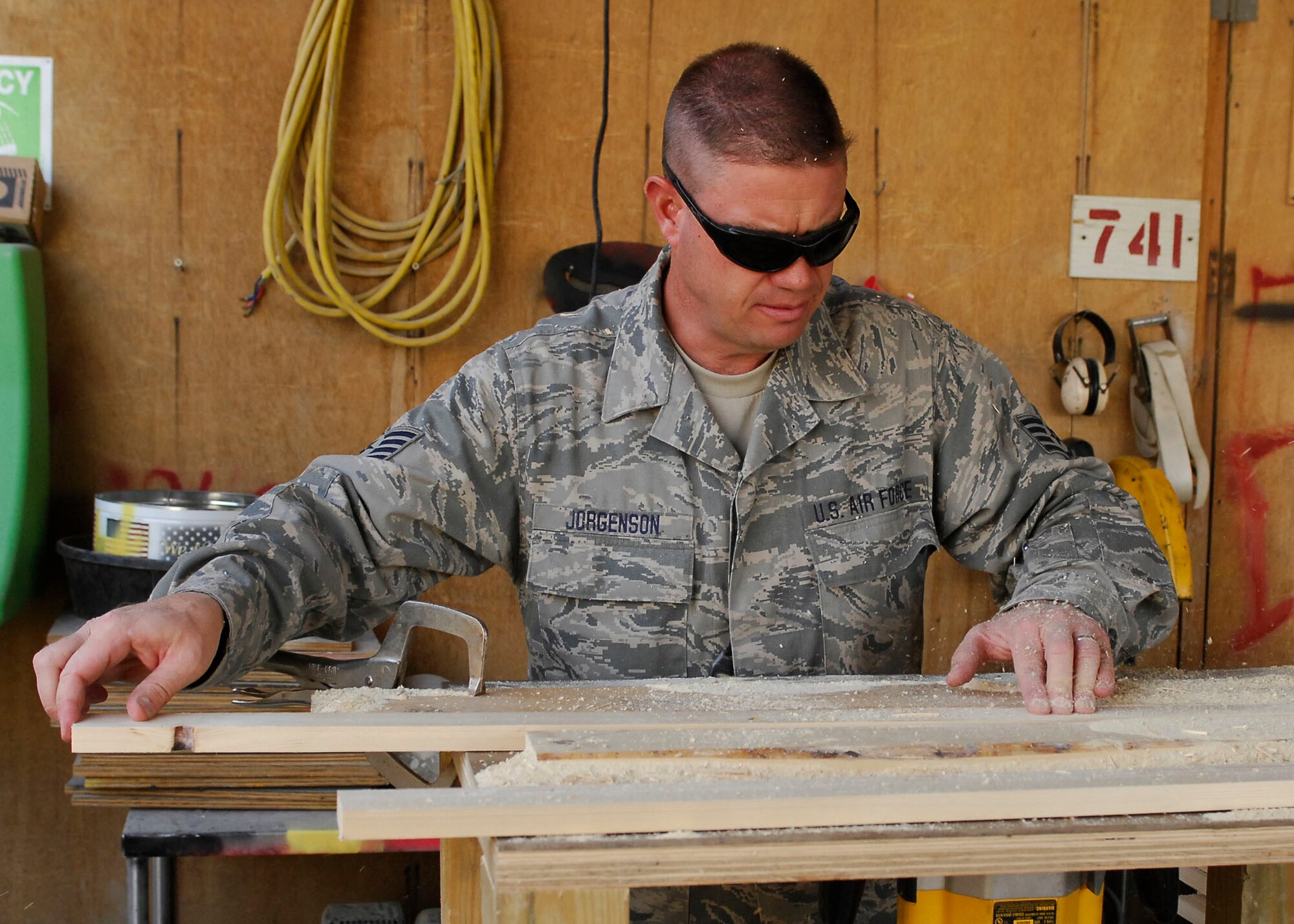 BAGRAM AIRFIELD, Afghanistan -- Staff Sgt. Troy Jorgenson, an engineering assistant from the 455th Expeditionary Civil Engineering Squadron, uses a router to cut away pieces of the plywood Oct. 29, 2009.  The wood will be used as picture frames for the wing headquarters building.  Sergeant Jorgenson is deployed from the Nevada Air National Guard's 152nd CES, and hails from Reno, Nev.  (U.S. Air Force photo/Senior Airman Felicia Juenke)