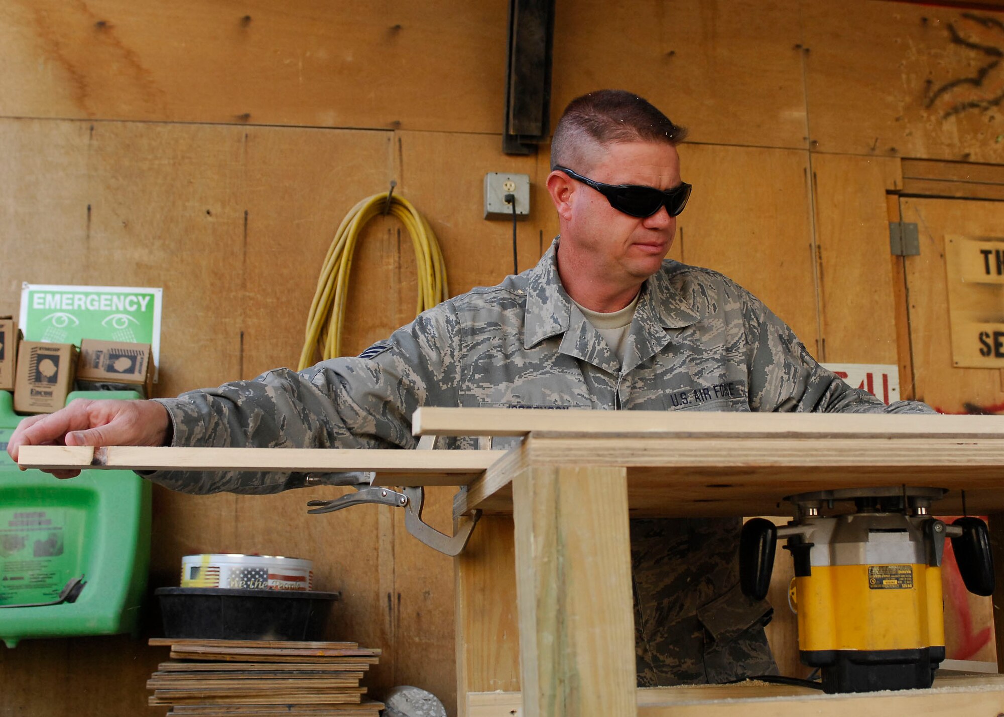 BAGRAM AIRFIELD, Afghanistan -- Staff Sgt. Troy Jorgenson, an engineering assistant from the 455th Expeditionary Civil Engineering Squadron, uses a router to cut the edges of plywood to make picture frames for the wing headquarters building Oct. 29, 2009.  The 455th ECES is responsible for building anything from frames to offices for the Air Force personnel on Bagram Airfield.  Sergeant Jorgenson is deployed from the Nevada Air National Guard's 152nd CES, and hails from Reno, Nev.  (U.S. Air Force photo/Senior Airman Felicia Juenke)