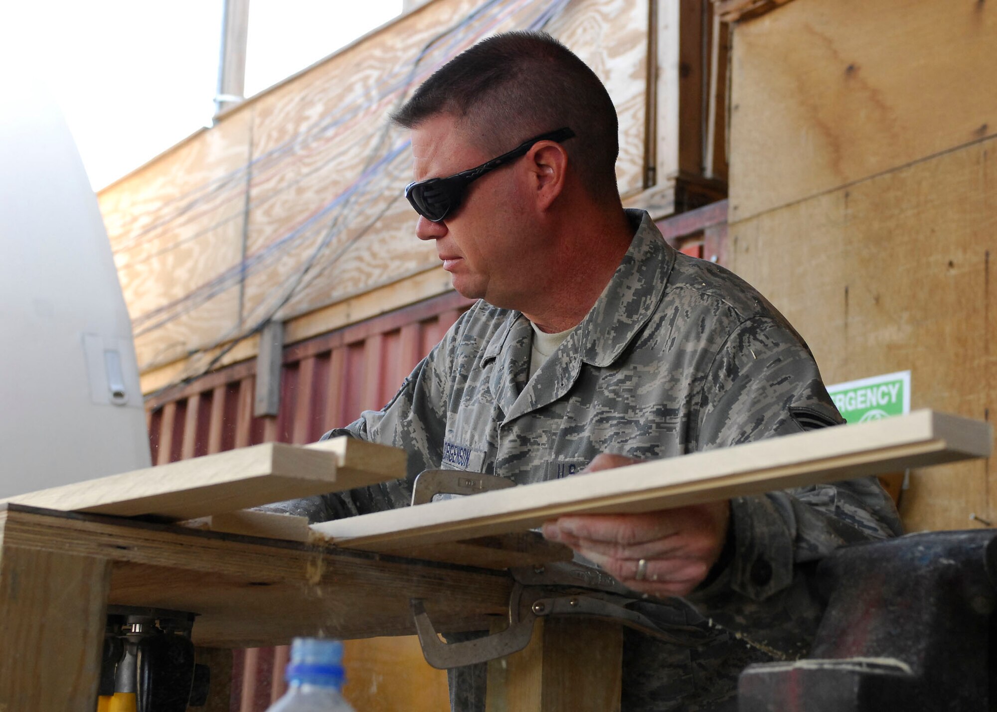 BAGRAM AIRFIELD, Afghanistan -- Staff Sgt. Troy Jorgenson, an engineering assistant from the 455th Expeditionary Civil Engineering Squadron, uses a router to cut away pieces of the plywood Oct. 29, 2009.  The wood will be used as picture frames for the wing headquarters building.  Sergeant Jorgenson is deployed from the Nevada Air National Guard's 152nd CES, and hails from Reno, Nev.  (U.S. Air Force photo/Senior Airman Felicia Juenke)