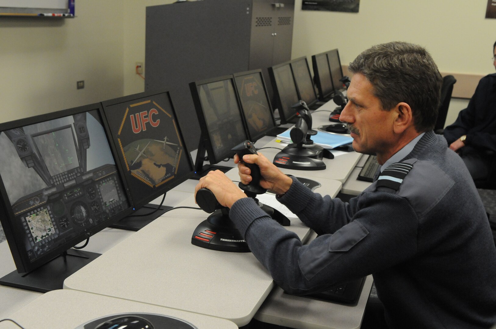 Air Marshal Simon Bryant, Royal Air Force air member for personnel and deputy commander-in-chief personnel, takes the controls of an unmanned aerial vehicle trainer, during his visit to the 563rd Flying Training Squadron at Randolph Air Force Base, Texas. (U.S. Air Force photo by Rich McFadden)