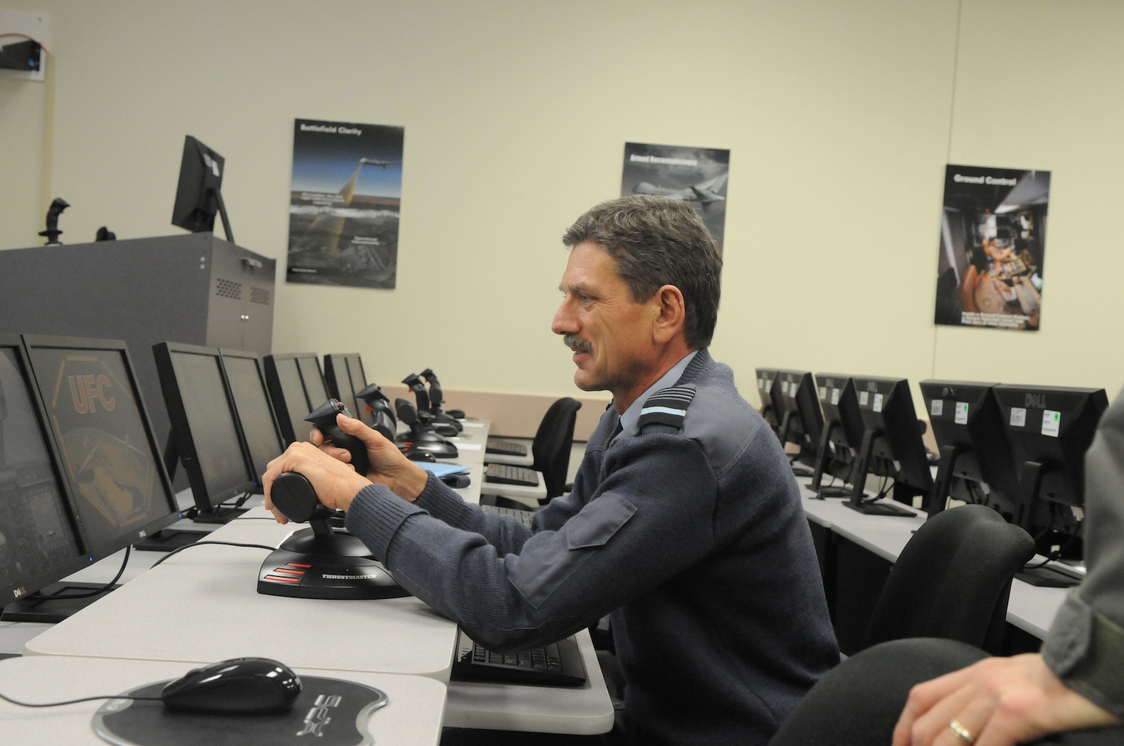 Air Marshal Simon Bryant, Royal Air Force air member for personnel and deputy commander-in-chief personnel, takes the controls of an unmanned aerial vehicle trainer, during his visit to the 563rd Flying Training Squadron at Randolph Air Force Base, Texas. (U.S. Air Force photo by Rich McFadden)