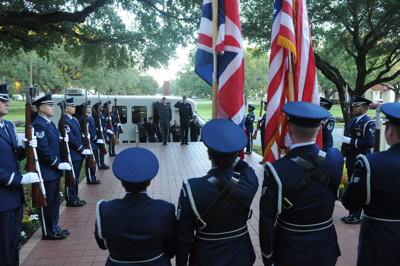 Air Marshal Simon Bryant, (center left) Royal Air Force air member for personnel and deputy commander-in-chief personnel, and General Stephen Lorenz, Air Education and Training Command commander, render salutes at an honors ceremony during the Royal Air Force visit to Headquarters AETC. (U.S. Air Force photo by Rich McFadden)