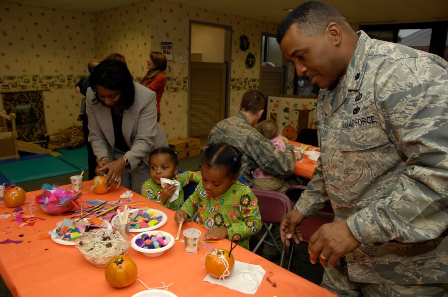HANSCOM AIR FORCE BASE, Mass. - The Hanscom Child Development Center hosted a Parent Child Pumpkin decorating activity on Oct. 27. Shown here, Lt. Col. Edwin McCain and his wife Yolanda help their twin daughters, Hope and Hannah pick just the right decorations for their pumpkins. Hanscom is celebrating Air Force Family Week next week with a number of events and activities across the base for families to participate in. For more information go to http://www.hanscom.af.mil/hanscomyearoftheairforcefamily/index.asp. (U.S. Air Force photo by Mark Herlihy)