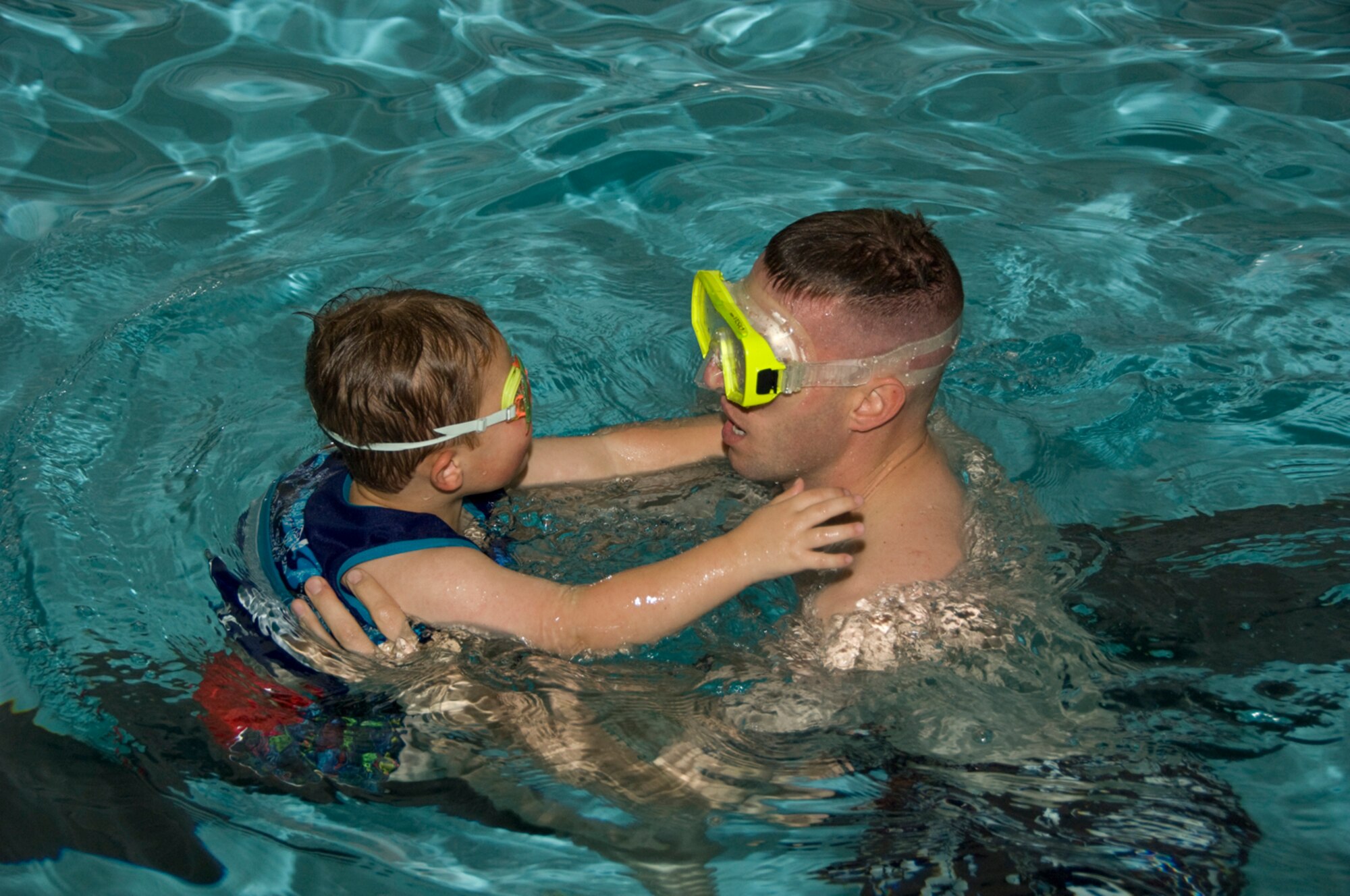 HANSCOM AIR FORCE BASE, Mass. - The Base Pool hosted Flick and Float on Oct. 23, shown here a father and son swim in the pool during the event. As part of Hanscom’s Air Force Family Week events there will be a free family pool party at the Base Pool from noon to 3 p.m. on Nov. 7, featuring DJ music, water games, hula hoop contest and prizes. Every family member will receive a slice of pizza, chips and juice. Call 781-377-8643 for more information. (U.S. Air Force Photo by Mark Herlihy)