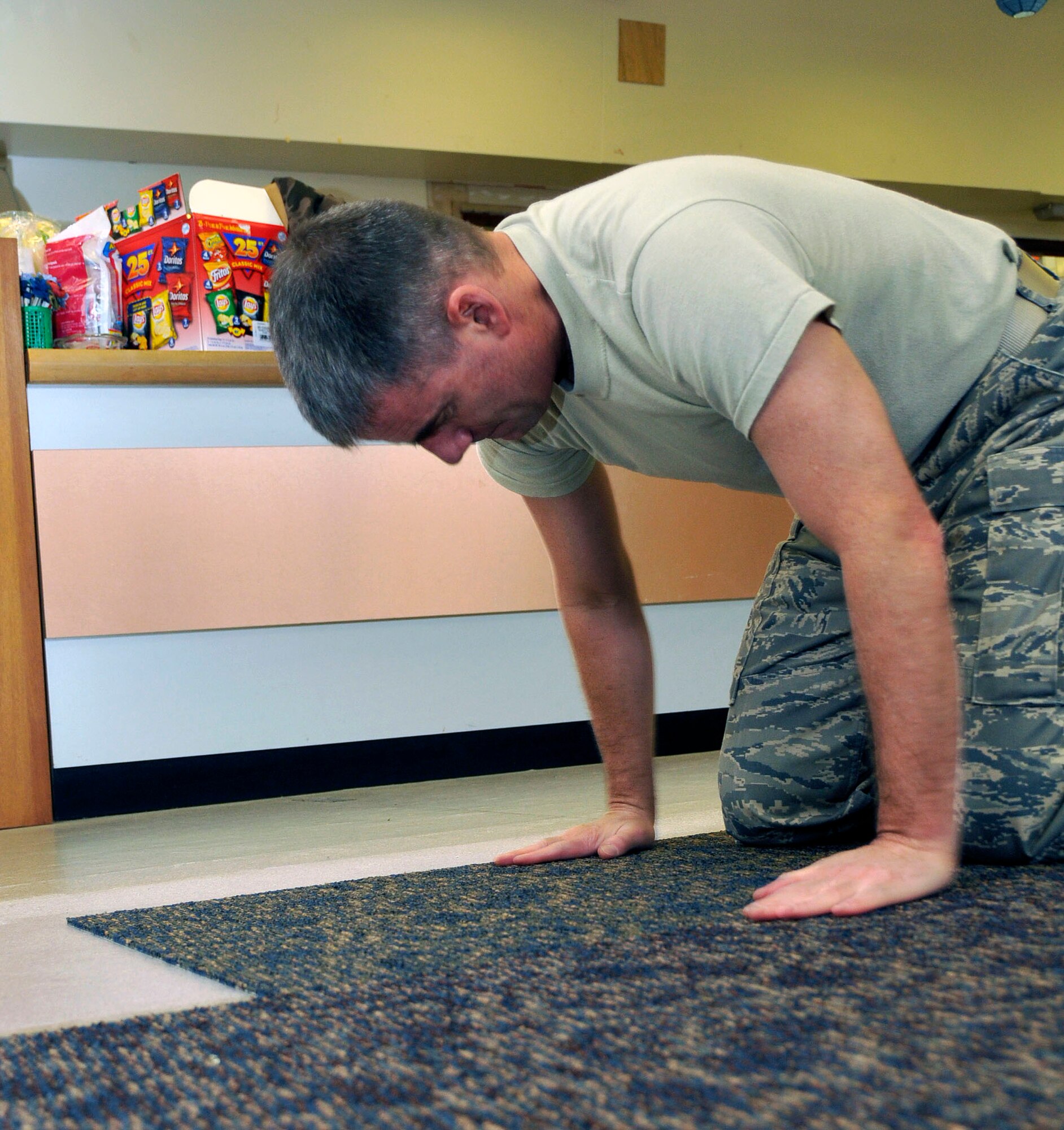 Col. Jay Silveria 48th Fighter Wing, commander, lays new carpet down for the base thrift store at RAF Lakenheath, England Oct. 27. The thrift store is being renovated and will have a grand opening Nov. 4. In the grand opening ceremony the new name for the store will be revealed. (U.S. Air Force photo/Airman 1st Class Eboni Knox)