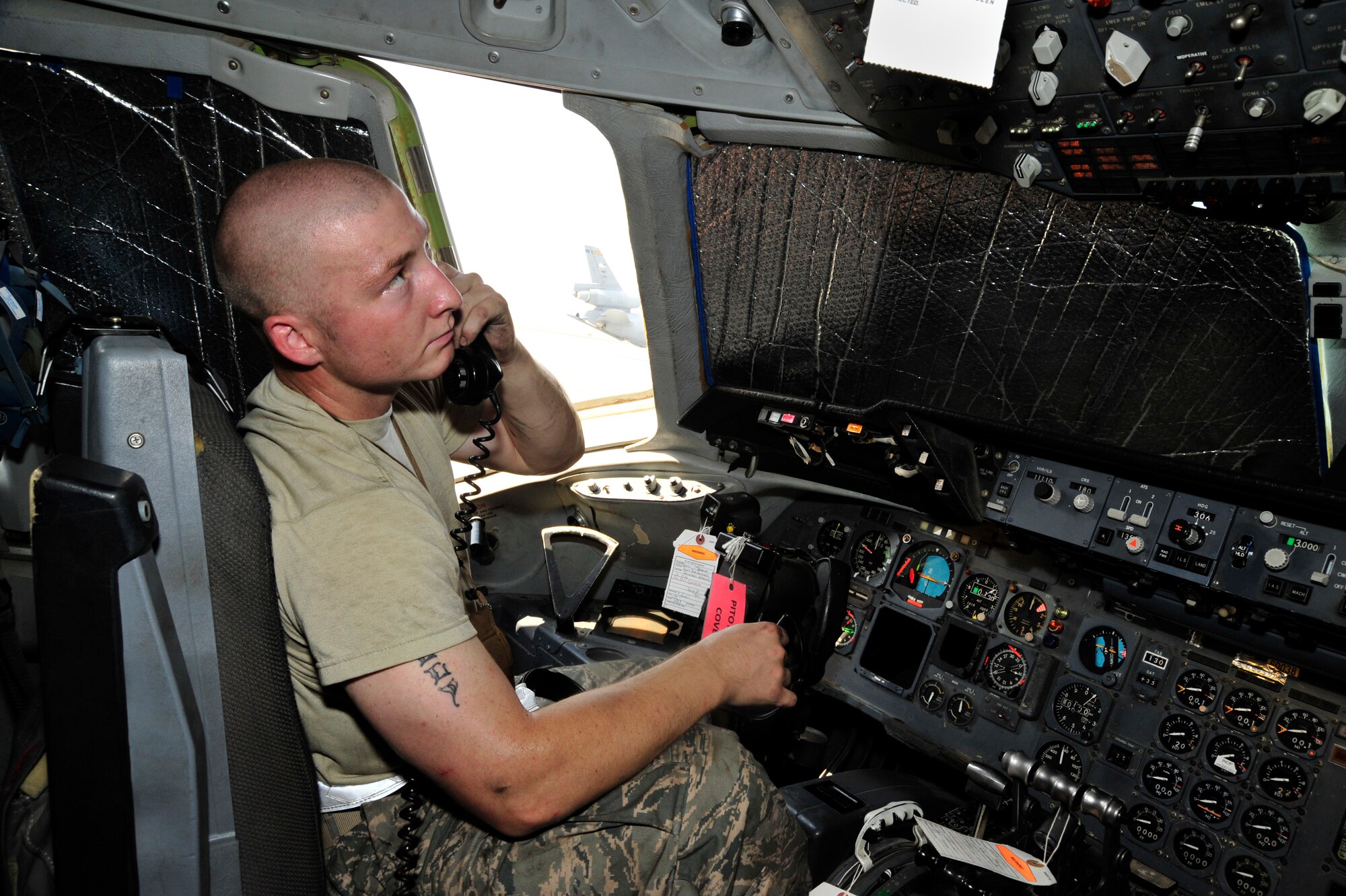 SOUTHWEST ASIA -Airman 1st Class Shaun Titemore, 380th Expeditionary Aircraft Maintenance Squadron, communicates with fellow maintainers while preparing a KC-10 Extender for an engine change Oct. 28, 2009. Airman Titemore is a jet propulsion systems mechanic deployed from Travis Air Force Base, Calif., and hails from Englewood, Colo. (U.S. Air Force photo/Tech. Sgt. Charles Larkin Sr)

