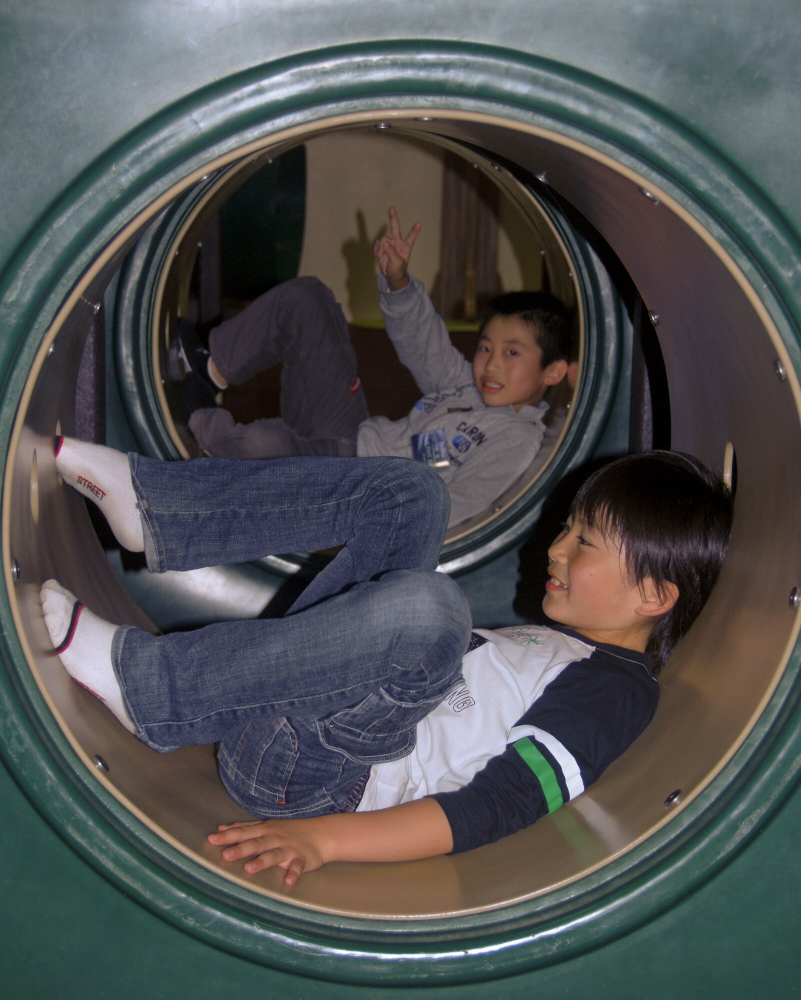 MISAWA AIR BASE, Japan -- Japanese children play at the Weasel's Den following the Misawa Air Fest Oct. 18, 2009. The children were part of a special group that was given the opportunity to meet the U.S. Air Force Thunderbirds following their air fest performance. (U.S. Air Force photo/Staff Sgt. Rachel Martinez)