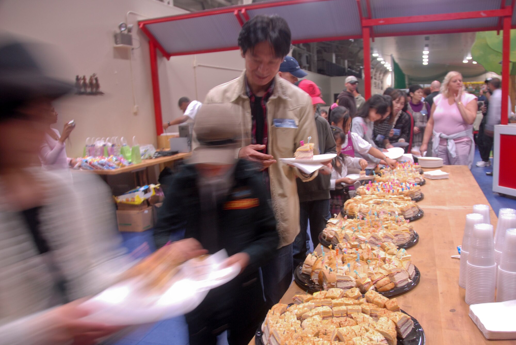 MISAWA AIR BASE, Japan -- Members of the local community line up for food at the Weasel’s Den following the Misawa Air Fest Oct. 18, 2009. More than 50 Japanese children, to include those with special needs,  and their family members were invited to the Weasel's Den following the air show, where they then had the opportunity to meet the U.S. Air Force Thunderbirds. (U.S. Air Force photo/Staff Sgt. Rachel Martinez)
