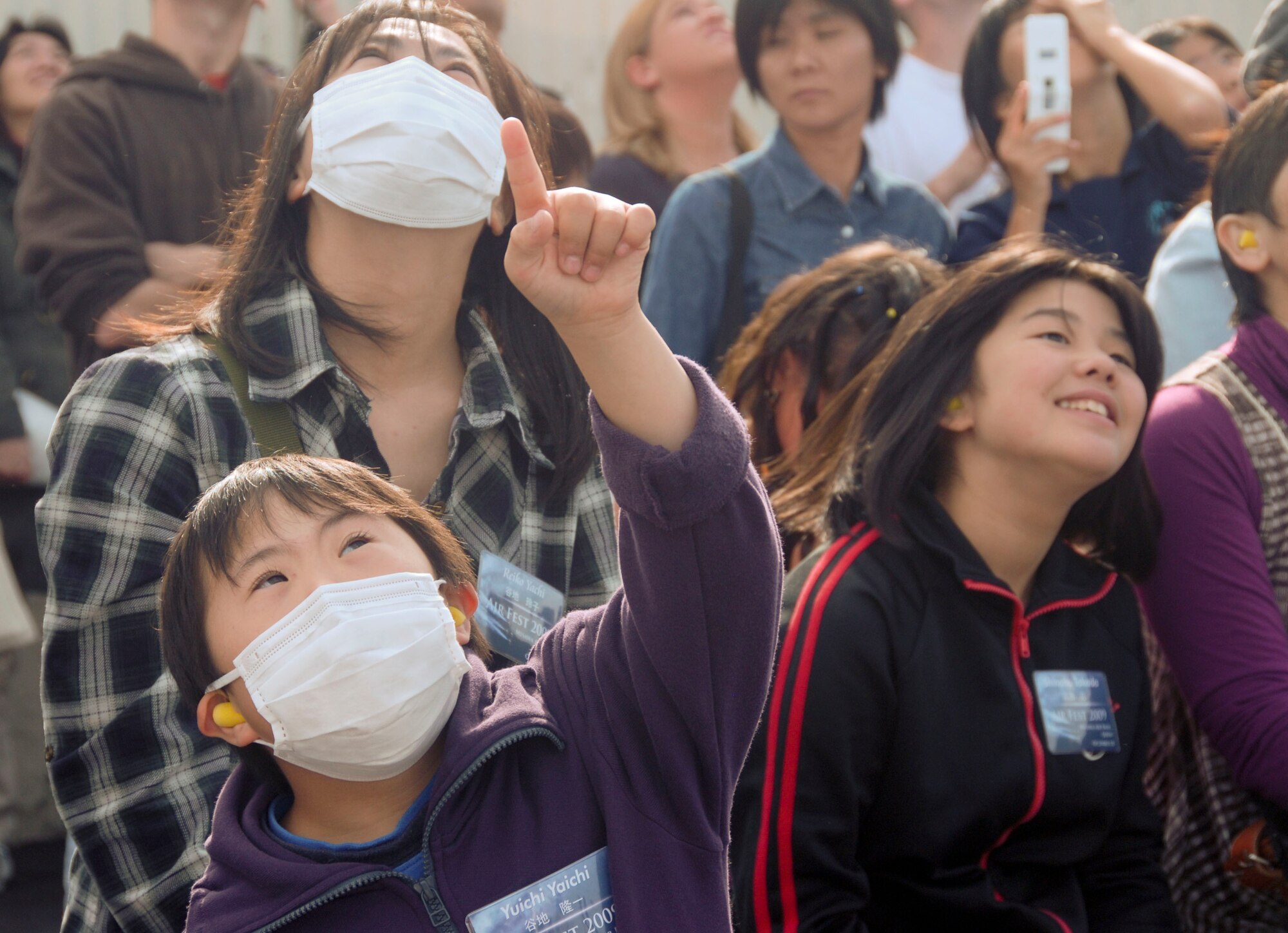 MISAWA AIR BASE, Japan -- Yuichi Yaichi points to the U.S. Air Force Thunderbirds as they maneuver above the crowd during the Misawa Air Fest Oct. 18, 2009. More than 50 Japanese children, to include those with special needs, and their parents were invited to take part in a unique community relations event that included viewing the air show, playing at the Weasel's Den and meeting the U.S. Air Force Thunderbirds. (U.S. Air Force photo/Staff Sgt. Rachel Martinez)