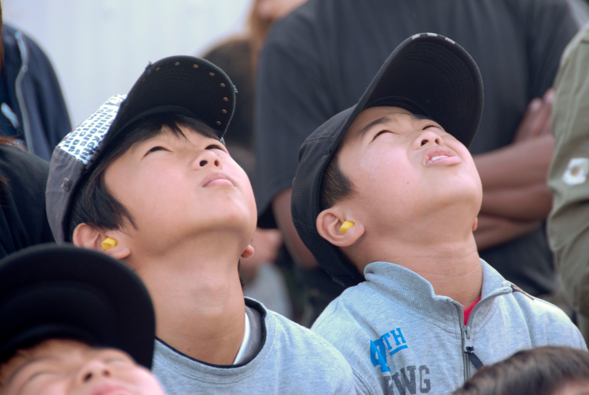 MISAWA AIR BASE, Japan -- Two boys look up as the U.S. Air Force Thunderbirds pass overhead during the Misawa Air Fest Oct. 18, 2009. More than 50 Japanese children, to include those with special needs, and their parents were invited to take part in a unique community relations event that included viewing the air show, playing at the Weasel's Den and meeting the U.S. Air Force Thunderbirds. (U.S. Air Force photo/Staff Sgt. Rachel Martinez)