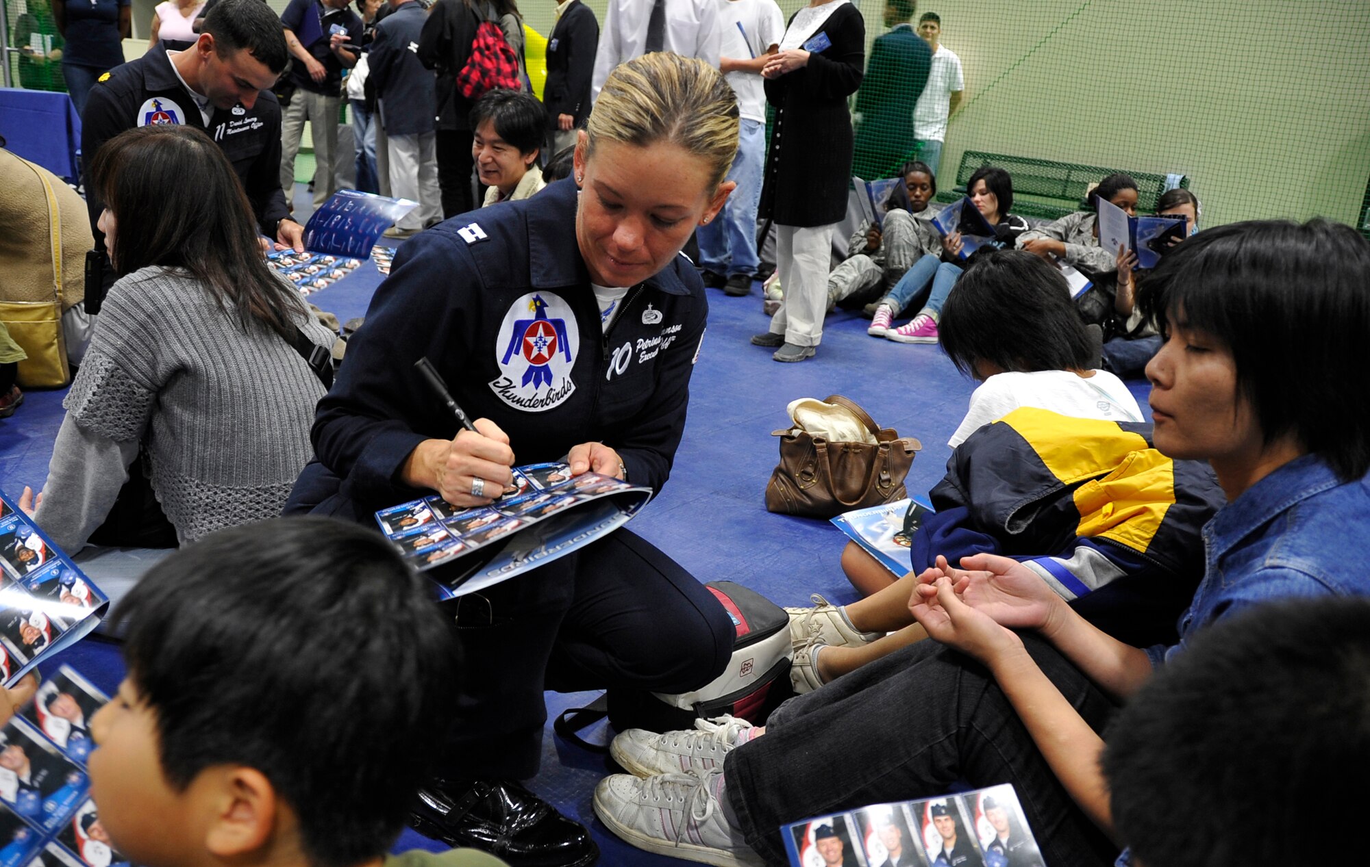 MISAWA AIR BASE, Japan -- Capt. Petrina Hanson, U.S. Thunderbirds pilot, answers questions and signs autographs at the Weasels' Den Oct. 18 after their performance during Air Fest 2009. Captain Hanson signed over 50 U.S. Thunderbirds programs. (U.S. Air Force photo/Staff Sgt. Chad C. Strohmeyer)