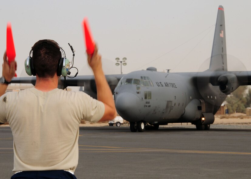 SOUTHWEST ASIA -- Senior Airman Garett Griffith, 386th Expeditionary Aircraft Maintenance Squadron crew chief, marshals a C-130 Hercules at an undisclosed location in Southwest Asia Oct. 28, 2009.  Airman Griffith is deployed from the 317th Aircraft Maintenance Squadron, Dyess Air Force Base, Texas and hails from Mansfield, Ark.  (U.S. Air Force photo/Tech. Sgt. Tony Tolley)