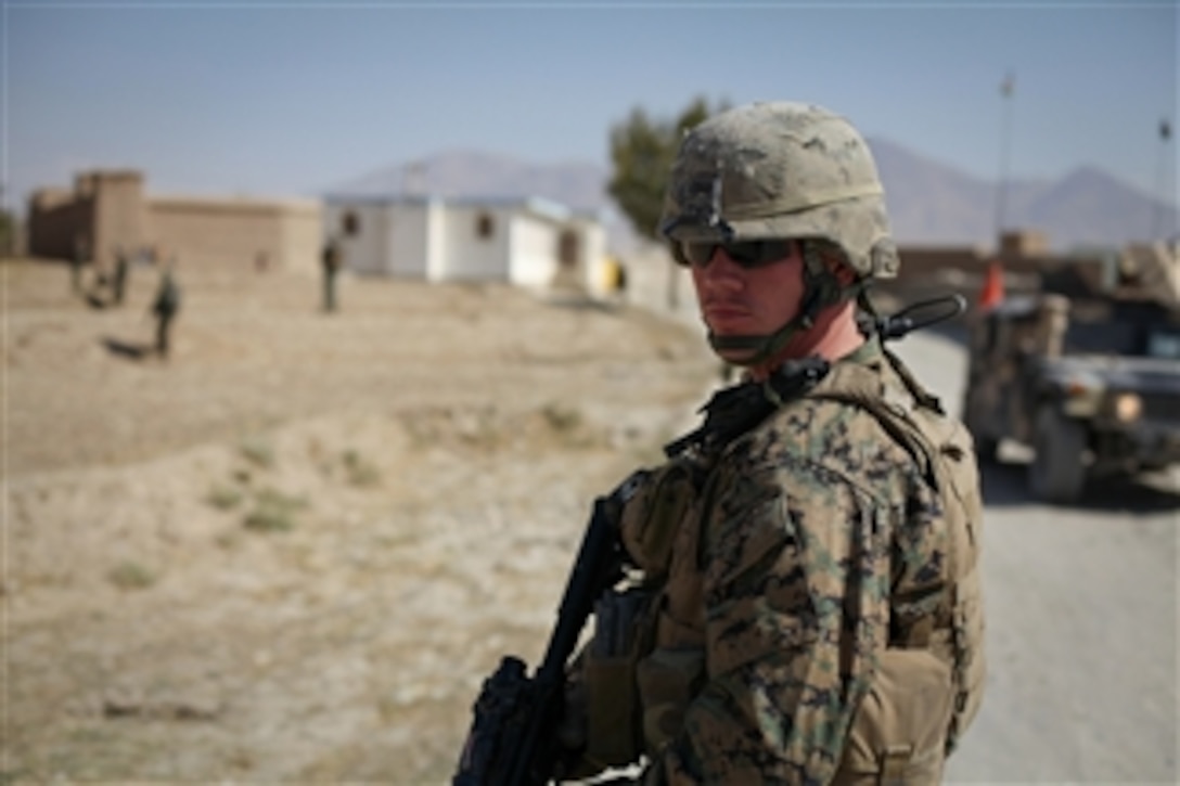 U.S. Marine Sgt. Robert Settle, assigned to Embedded Training Team 1-12th, conducts a joint patrol with Afghan National army soldiers and U.S. Army soldiers, from 10th Mountain Division, across the Nerkh district, in Wardak province, Afghanistan, on Oct. 21, 2009.  