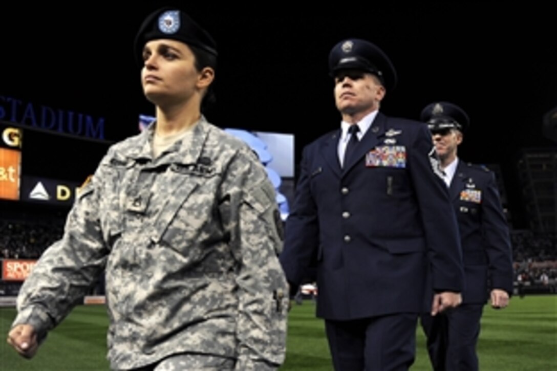 Wounded warriors march off the field as part of the opening ceremonies of the first game of the World Series between the Philadelphia Phillies and the New York Yankees at Yankee Stadium in New York, Oct. 28, 2009.  