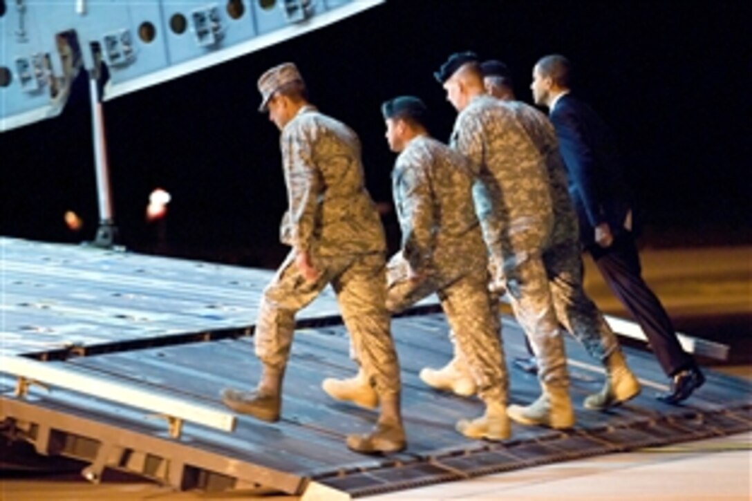 From right, President Barack Obama, Army Maj. Gen. Daniel V. Wright, Army Brig. Gen. Michael S. Repass, Army Command Sgt. Maj. Mario Vigil and Air Force Chief of Staff Gen. Norton A. Schwartz board a C-17 Globemaster III aircraft during the dignified transfer of Army Sgt. Dale R. Griffin on Dover Air Force Base, Del., Oct. 29, 2009.