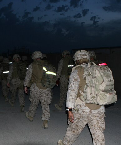 Naval officers aboard Camp Al Taqaddum, Iraq, conducted a hike led by First Sgt. Theresa G. Harris, Headquarters and Service Company first sergeant and Capt. George D. Camia, the company commander, as a requirement to receive their Fleet Marine Force Qualified Officer pins, Oct. 31, 2009.  The hike is just one crucial step the sailors have to complete in order to receive their pin; an honor available to only those sailors who serve side-by-side with Marines.  (U.S. Marine Corps photograph by Lance Cpl. Melissa A. Latty)