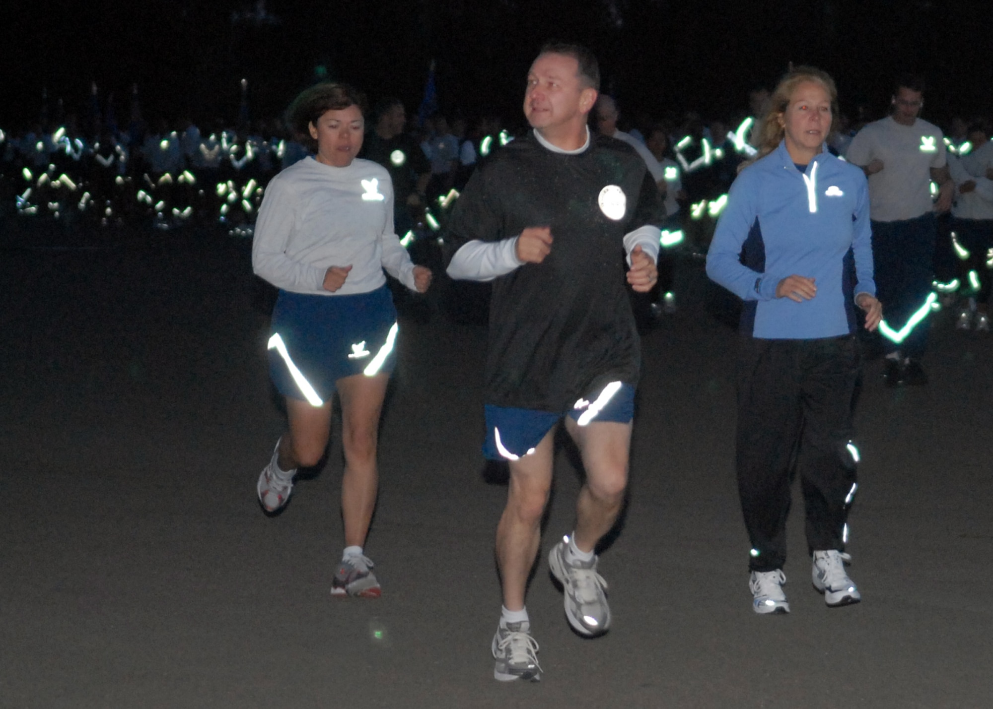 VANDENBERG AIR FORCE BASE, Calif. - Leading the way, Col. Steven Winters, the 30th Space Wing vice commander, Chief Master Sgt. Angelica Johnson, the 30th SW command chief, and Stella Buck, a 14th Air Force paralegal, run ahead of the crowd during the Fit-to-Fight Run here Friday, Oct. 30, 2009. The event takes place at the close of every month to maintain the Air Force’s health and fitness standards. (U.S. Air Force photo/Airman 1st Class Angelina Drake) 