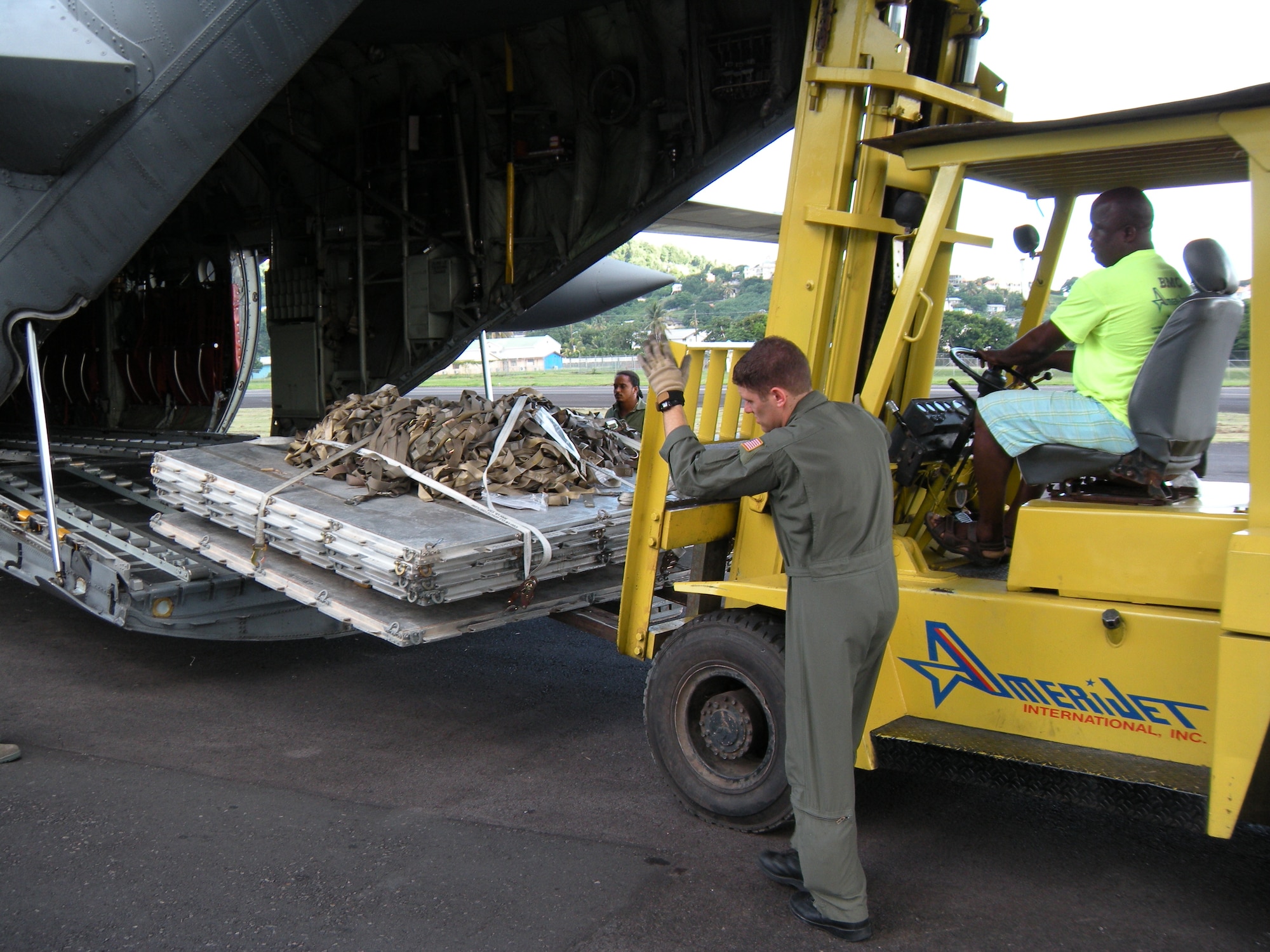 Staff Sgt. James Jorgensen, 731st Airlift Squadron loadmaster, helps to guide a forklift into position to re-load pallets on to a 302nd Airlift Wing C-130 Hercules Oct. 30 after delivering humanitarian supplies to the Caribbean island of St. Vincent. The supplies, donated by Wausau, Wis.-based Good News Project, included hospital and mental health supplies as well as desks, paper and school supplies to various locations on the island. The Air Force Reserve aircraft hauled the supplies under the Denton Amendment, which authorizes U.S. military aircraft via Congress to airlift humanitarian supplies based on space availability and other factors. (U.S. Air Force photo/Staff Sgt. Stephen J. Collier)