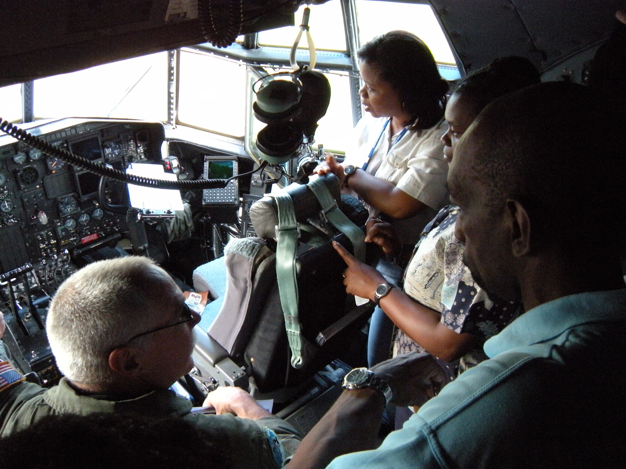 Master Sgt. Ray Wiebe, a C-130 Hercules flight engineer, gives a tour off the aircraft to local officials Oct. 30 after the delivery of humanitarian supplies to the Caribbean island of St. Vincent. The supplies, donated by Wausau, Wis. based Good News Project, included hospital and mental health supplies as well as desks, paper and school supplies to various locations on the island. The Air Force Reserve aircraft transported the supplies under the Denton Amendment, which authorizes U.S. military aircraft via Congress to airlift humanitarian supplies based on space availability and other factors. The C-130 is assigned to the Air Force Reserve Command's 302nd Airlift Wing based at Peterson Air Force Base, Colo. (U.S. Air Force photo/Staff Sgt. Stephen J. Collier)