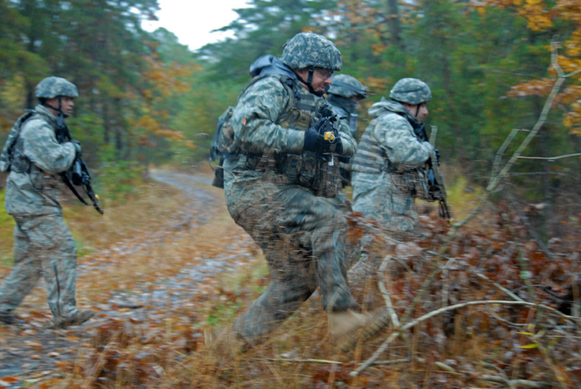 Air Force Tech. Sgt. Dave Marcelli, 113th Security Forces Squadron Fire Team member, seeks cover under simulated fire during unmounted patrol training on October 27, 2009. The 113SFS is engaged in pre-deployment training exercises conducted by the U.S. Air Force Expeditionary Center's 421st Combat Training Squadron at Joint Base McGuire-Dix-Lakehurst, N.J. (U.S. Air Force photo/Tech. Sgt. Adrianne L. Wilson)