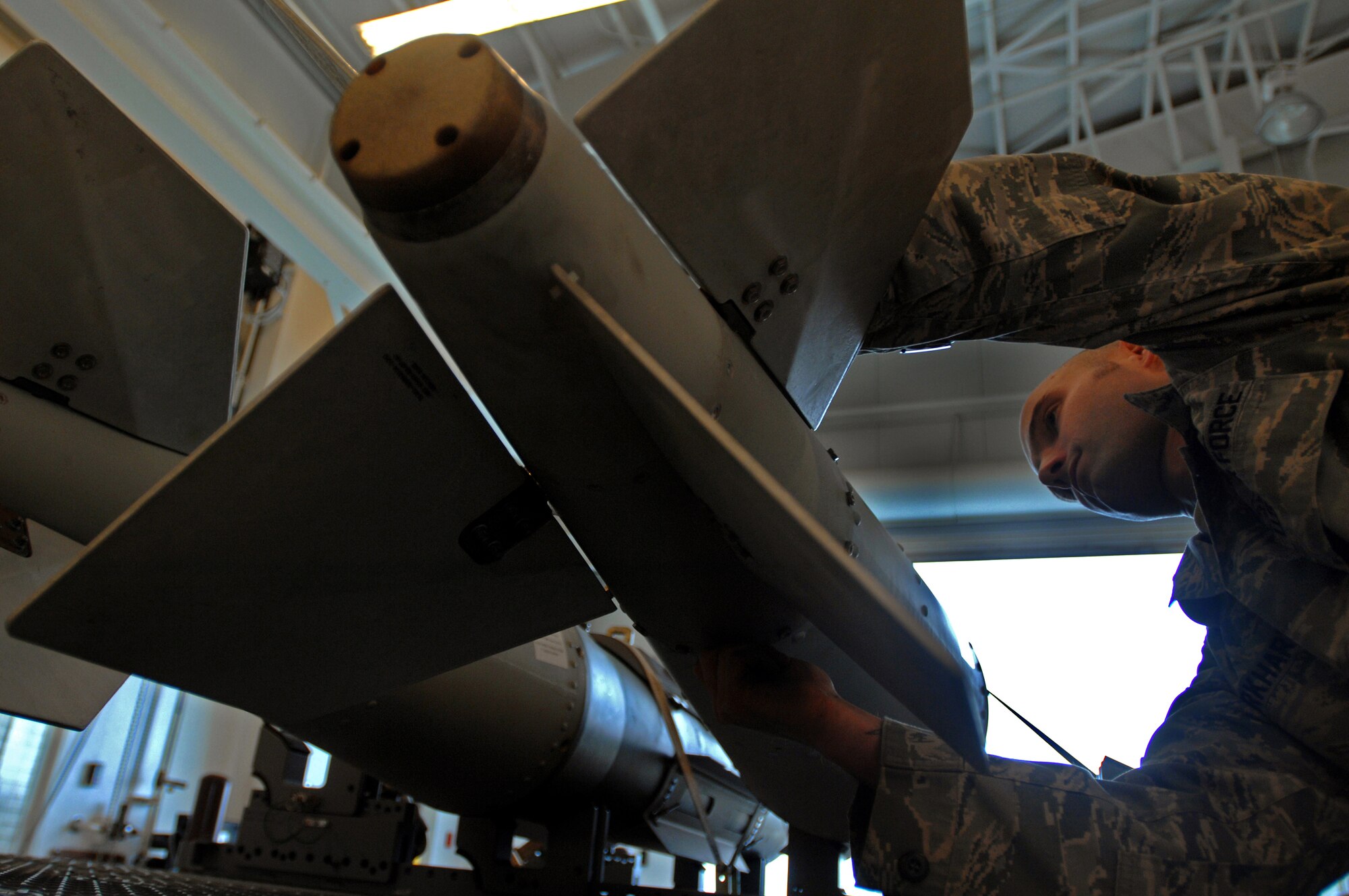 WHITEMAN AIR FORCE BASE, Mo., - Staff Sgt. John Burkhart, 131st Maintenance Squadron conventional maintenance crew chief, ensures the fin bolts are tightened on a GBU 31 weapon, during a post assembly inspection, Oct. 23. Sergeant Burkhart and other members of the 131st MXS build and maintain 11 different types of guided weapons. (U.S. Air Force photo/Senior Airman Kenny Holston)(Released) 