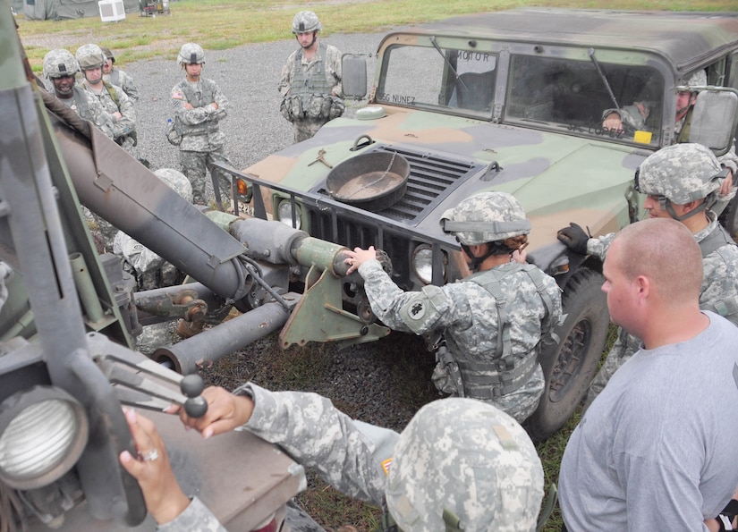 SOTO CANO AIR BASE, Honduras — Soldiers from 1st Battalion, 228th Aviation Regiment hook a humvee up to a Heavy Expanded Mobility Tactical Truck, or HEMTT, Oct. 28 behind the base rappelling station during the wrecker operations portion of a three-day exercise. Soldiers from the 1-228th Aviation Regiment recently turned their focus from helicopter operations to some basic Soldier field training from Oct. 25 to 29. Some of the things taught during the training were: practicing recall procedures, setting up tents, radio communications, convoy operations, combat medicine, vehicle staging, wrecker operations, M-249 light machine gun familiarization and firing the M-249 at the range (U.S. Air Force photo/Staff Sgt. Chad Thompson).