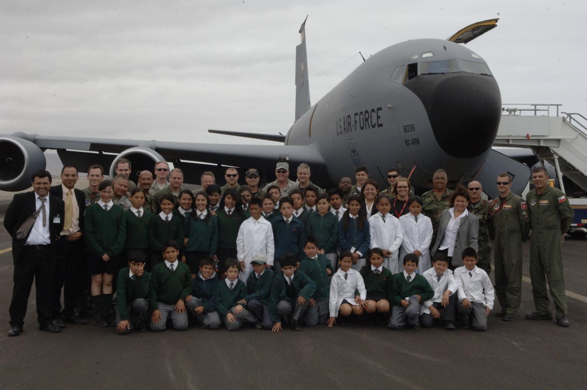 IQUIQUE, Chile -- Chilean and U.S. Airmen, children and teachers from Colegio Macaya school in Alto Hospicia pose for a group photo in front of a KC-135 during a base tour here Oct. 30. Students were invited to the base to see U.S. and Chilean Air Force aircraft, and meet Airmen. (U.S. Air Force photo by Tech. Sgt. Eric Petosky)