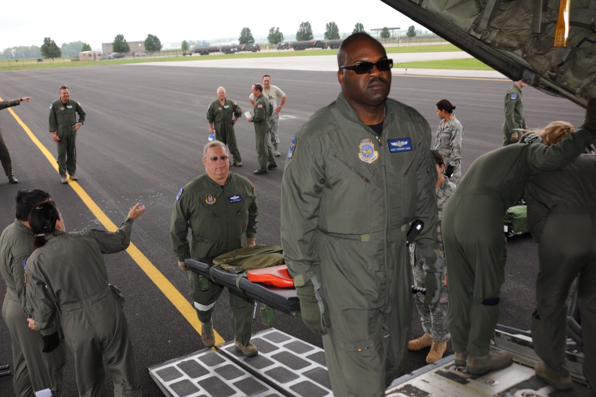 A group of aeromedical technicians load a litter aboard a C-130 plane at the 932nd Airlift Wing.  They flew on a three day mission to Florida courtesy of the 302nd Airlift Wing.  (U.S. Air Force photo by Maj. Stan Paregien)