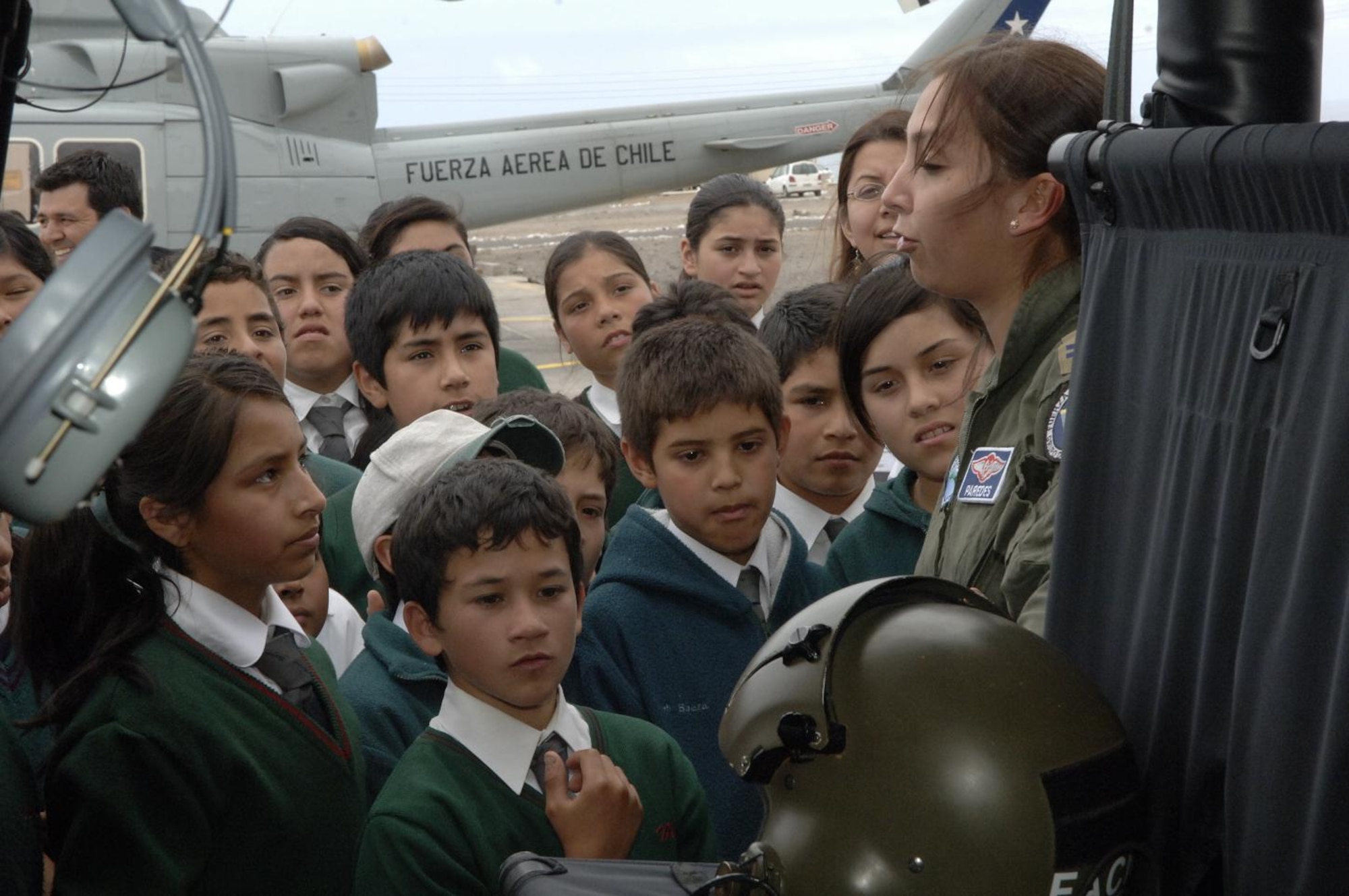 IQUIQUE, Chile -- 1st Lt. Pamela Paredes, Fuerza Aerea De Chile Bell 412 and UH-1H helicopter pilot, explains the Bell 412 to students of Colegio Macaya during a base tour here Oct. 30. Students were invited to the base to see U.S. and Chilean Air Force aircraft, and meet Airmen. (U.S. Air Force photo by Tech. Sgt. Eric Petosky)