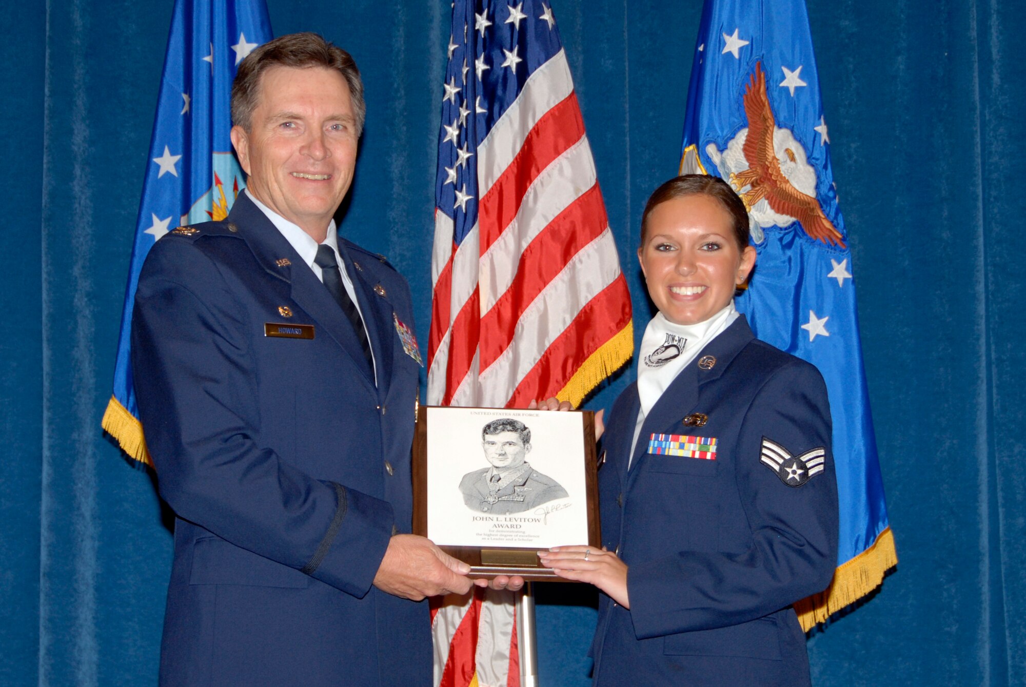 McGHEE TYSON AIR NATIONAL GUARD BASE, Tenn. -- Senior Airman Jennifer M. Kuklenski, an intelligence analyst with the 148th Fighter Wing, Minnesota Air National Guard, receives the John L. Levitow award from Col. Richard B. Howard, commander, for her accomplishments at Airman Leadership School Class 09-6 at The I.G. Brown Air National Guard Training and Education Center here, Oct. 29, 2009.  The John L. Levitow Award is the highest honor awarded a graduate of any Air Force enlisted professional military education course.  (U.S. Air Force photo by Master Sgt. Kurt Skoglund)