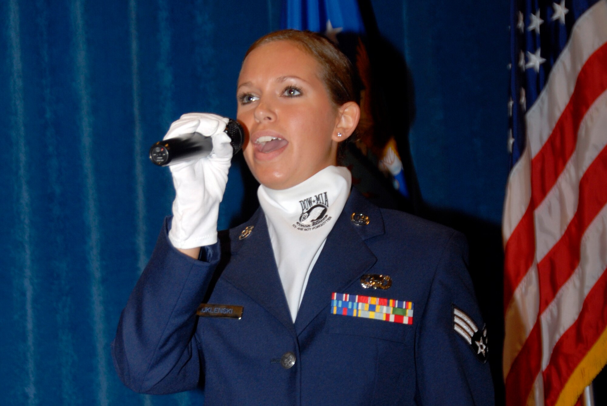 McGHEE TYSON AIR NATIONAL GUARD BASE, Tenn. -- Senior Airman Jennifer M. Kuklenski, an intelligence analyst with the 148th Fighter Wing in Duluth, Minn., sings the national anthem during the graduation ceremony of Airman Leadership School Class 09-6 at The I.G. Brown Air National Guard Training and Education Center here, Oct. 29, 2009.  Kuklenski was a member of A-Flight.  (U.S. Air Force photo by Master Sgt. Kurt Skoglund/Released)