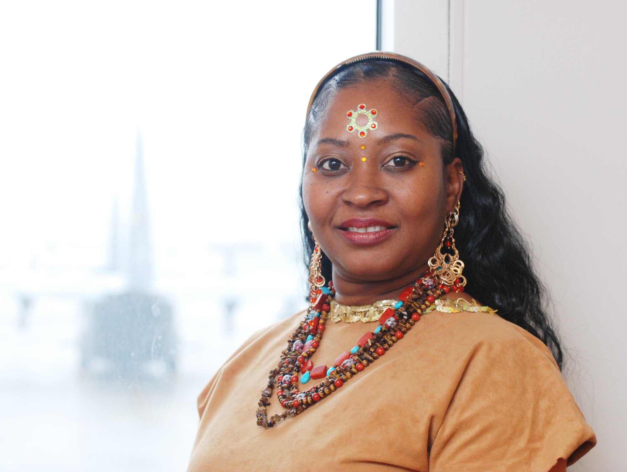 Jeweled up and ready for a Halloween weekend, Lena Bell, 94th Operations Group administrative assistant, sports a mixture of Pocahontas and Bollywood-style fashion jewelry for her costume on Friday, Oct 30. 

Halloween is traditionally a dress up day for office workers at Dobbins ARB and in the Atlanta metro area.  Bollywood is an informal term used for Hindi or Asian Indian styled film industry.  The fashion items are associated with Indian culture.  (U.S. Air Force photo/Master Sgt. Stan Coleman)
