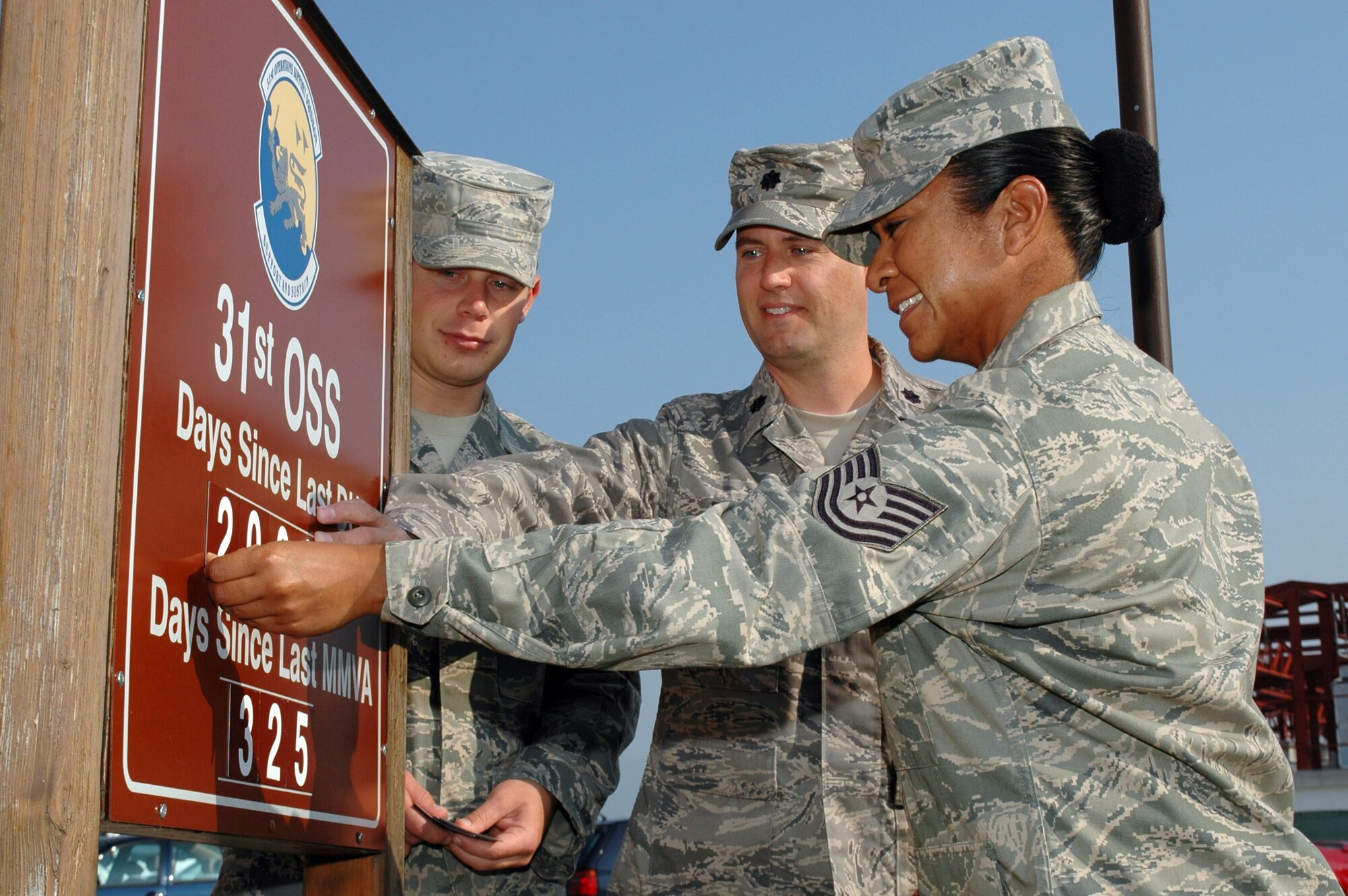 Lt. Col. Sean DeWitt, Tech. Sgt. Gracey Martinez and Airman 1st Class Andrew Meyer update their unit's driving under the influence and major motor vehicle accident sign Sept. 28, 2009, to the 2,000th day since a DUI at Aviano Air Base, Italy. The commander had the two Airmen who've been assigned to the unit the longest, that being Sergeant Martinez, and the least, Airman Meyer, update the sign with him as some sort of passing of the torch in keeping safety at the forefront of everyone's mind in the unit. Colonel DeWitt is the 31st Operations Support Squadron commander. (U.S. Air Force photo/Tech. Sgt. Michael O'Connor) 