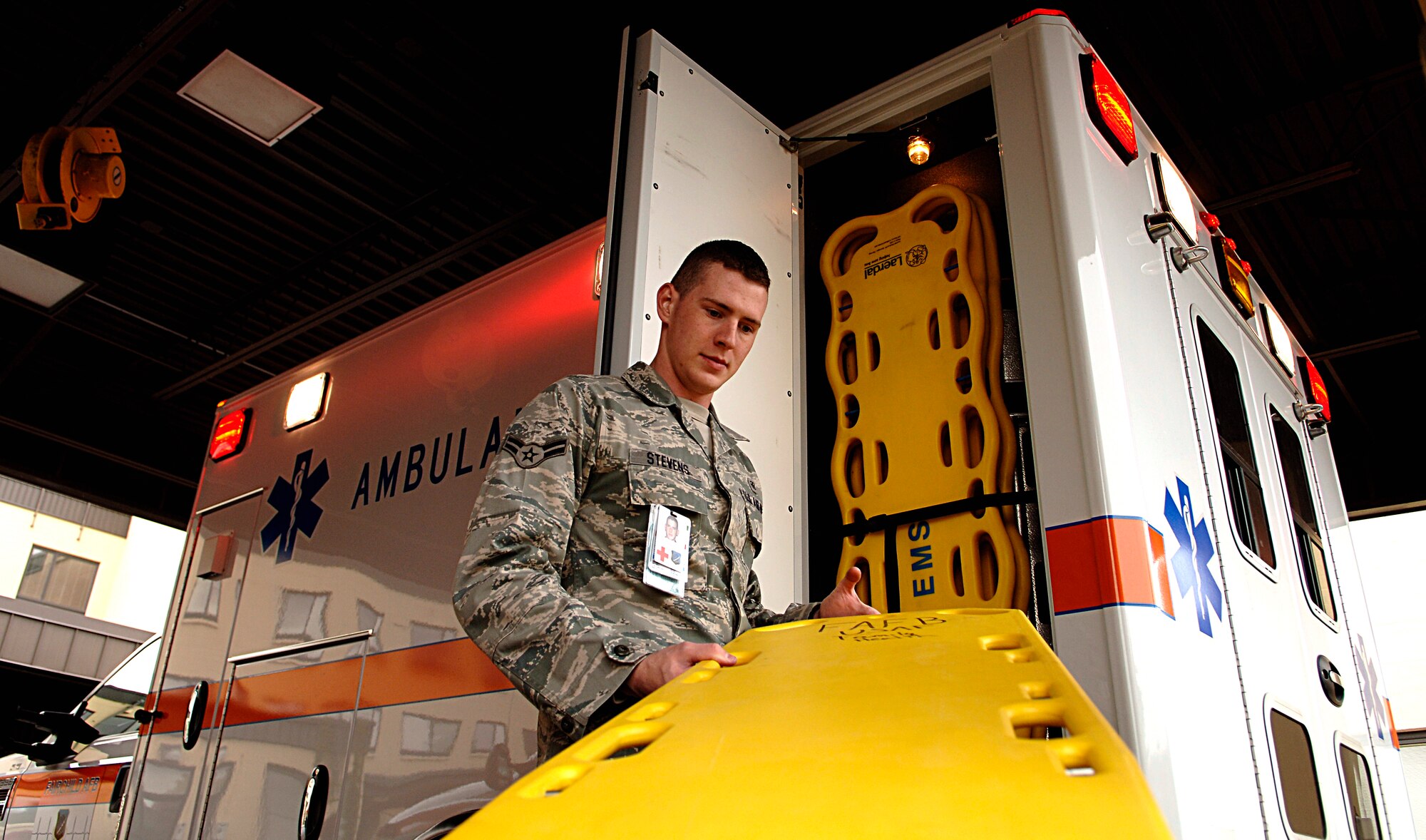 FAIRCHILD AIR FORCE BASE, Wash. – Airman 1st Class Michael Stevens, 92nd Medical Dental Squadron medical technician, removes one of the spine boards stocked in an ambulance Oct. 22.The spine board is used for the immobilization and transportation of patients with suspected spinal injuries. (US Air Force photo/Airman 1st Class Natasha E. Stannard)
