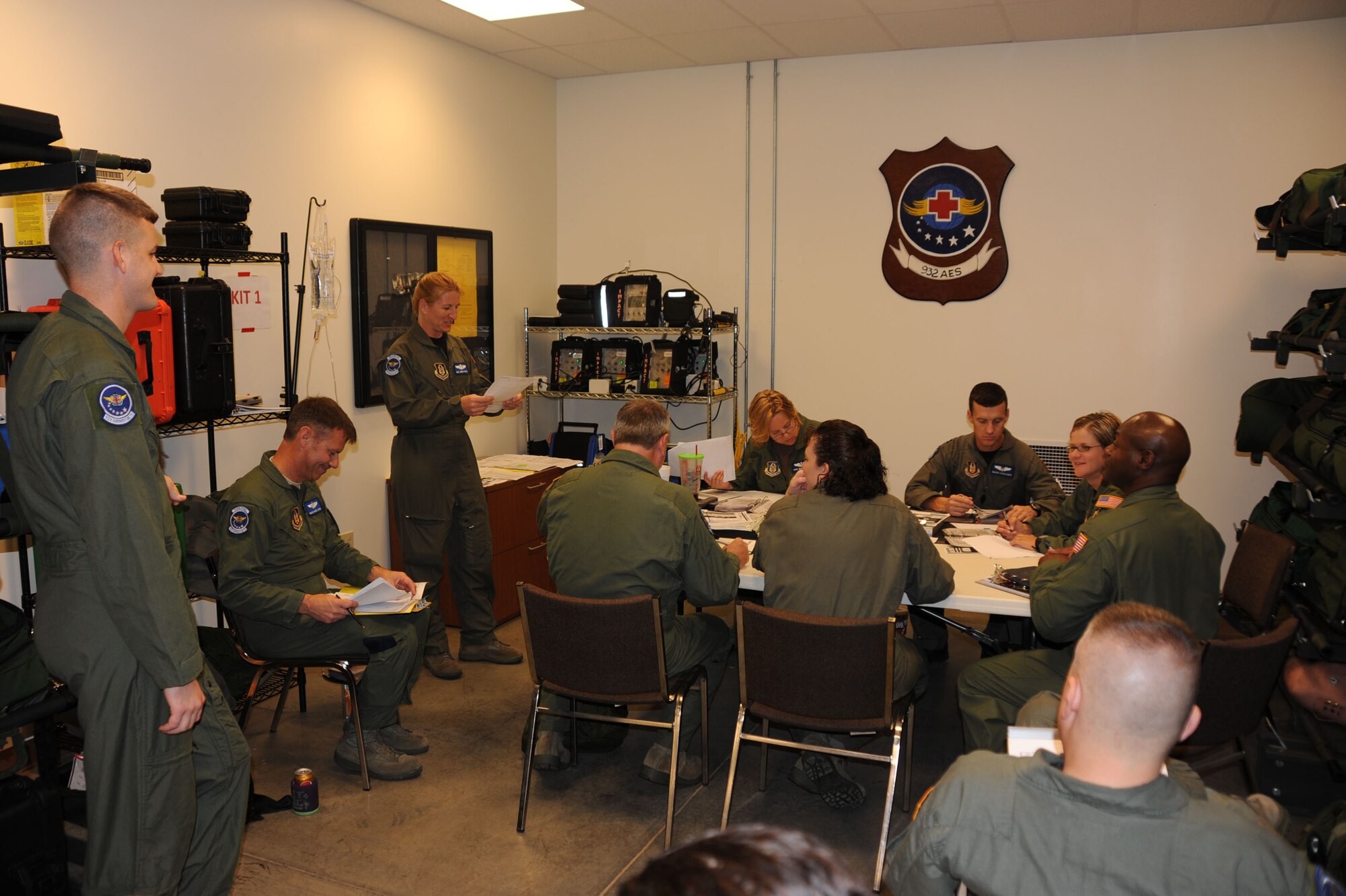 A group of aeromedical technicians have an early morning meeting as they get ready for a training flight at the 932nd Airlift Wing.  (Air Force photo by Tech. Sgt. Gerald Sonnenberg)
