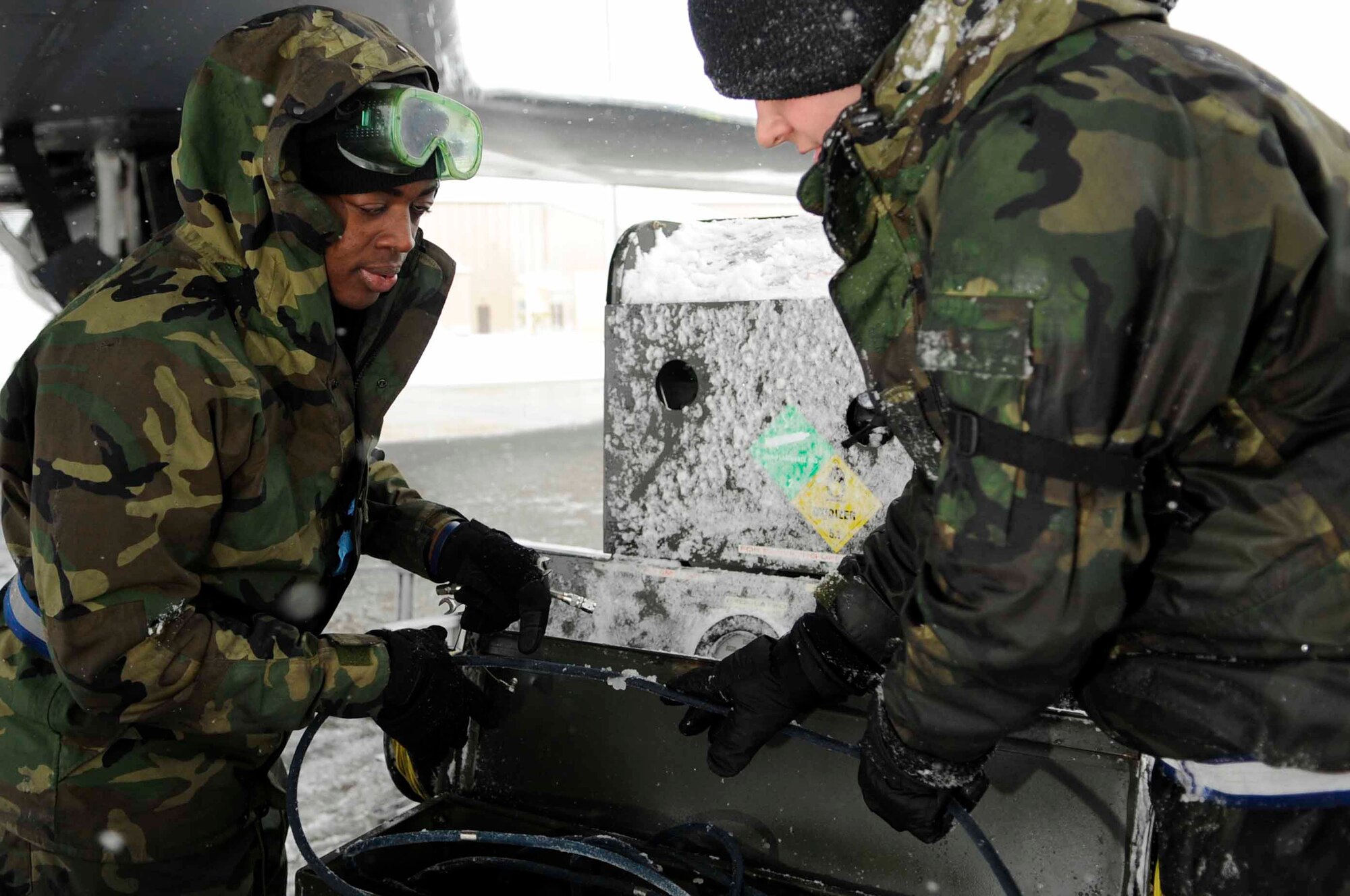 ELLSWORTH AIR FORCE BASE, S.D.-- (Left) Airman 1st Class Samuel Carr and Christopher Price, 28th Aircraft Maintenance Squadron crew chiefs, put away a gaseous oxygen system, Oct. 29. The gaseous oxygen system provides oxygen for aircrew use at high altitudes. (U.S. Air Force photo/Airman 1st Class Corey Hook)