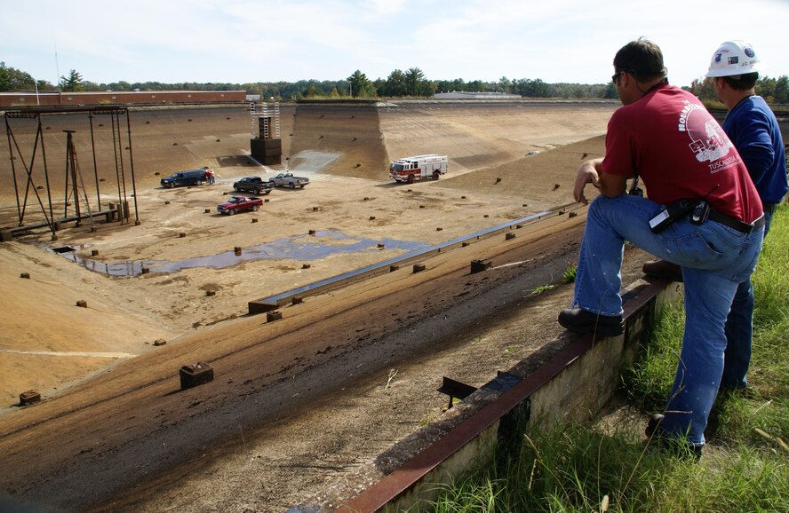 ATA’s Test and Facility Support crew supervisor John Berlan and ATA Outside Machinist John Richardson stand on the west bank of the secondary reservoir watching as a major repair project was underway on the 56-million gallon capacity reservoir. (Photo by Philip Lorenz)