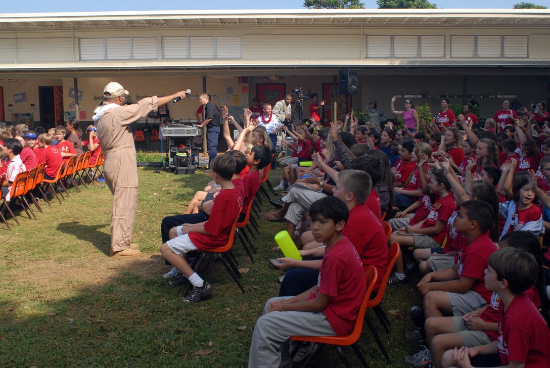 HICKAM AIR FORCE BASE, Hawaii -- Tech. Sgt. Richard Vasquez, U.S. Air Force Band of the Pacific vocalist, sings to a crowd of Hickam Elementary School students here, Oct. 29. Hickam, one of two elementary schools on base, was one of six schools the band performed for in support of Red Ribbon Week. Red Ribbon Week focuses on living and maintaining a drug free lifestyle. (U.S. Air Force photo/Senior Airman Gustavo Gonzalez)